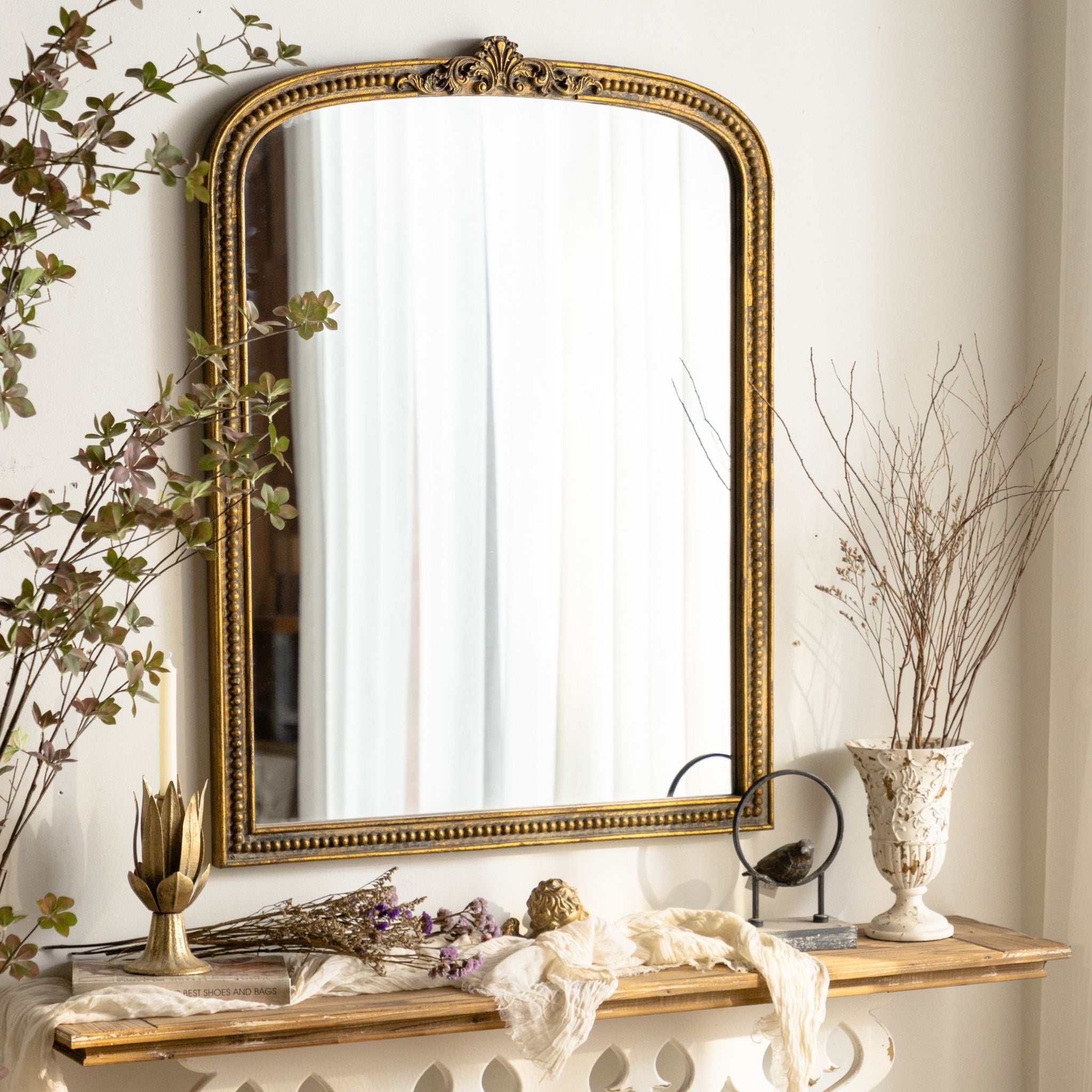 Renata arched wall mirror styled above a mantel