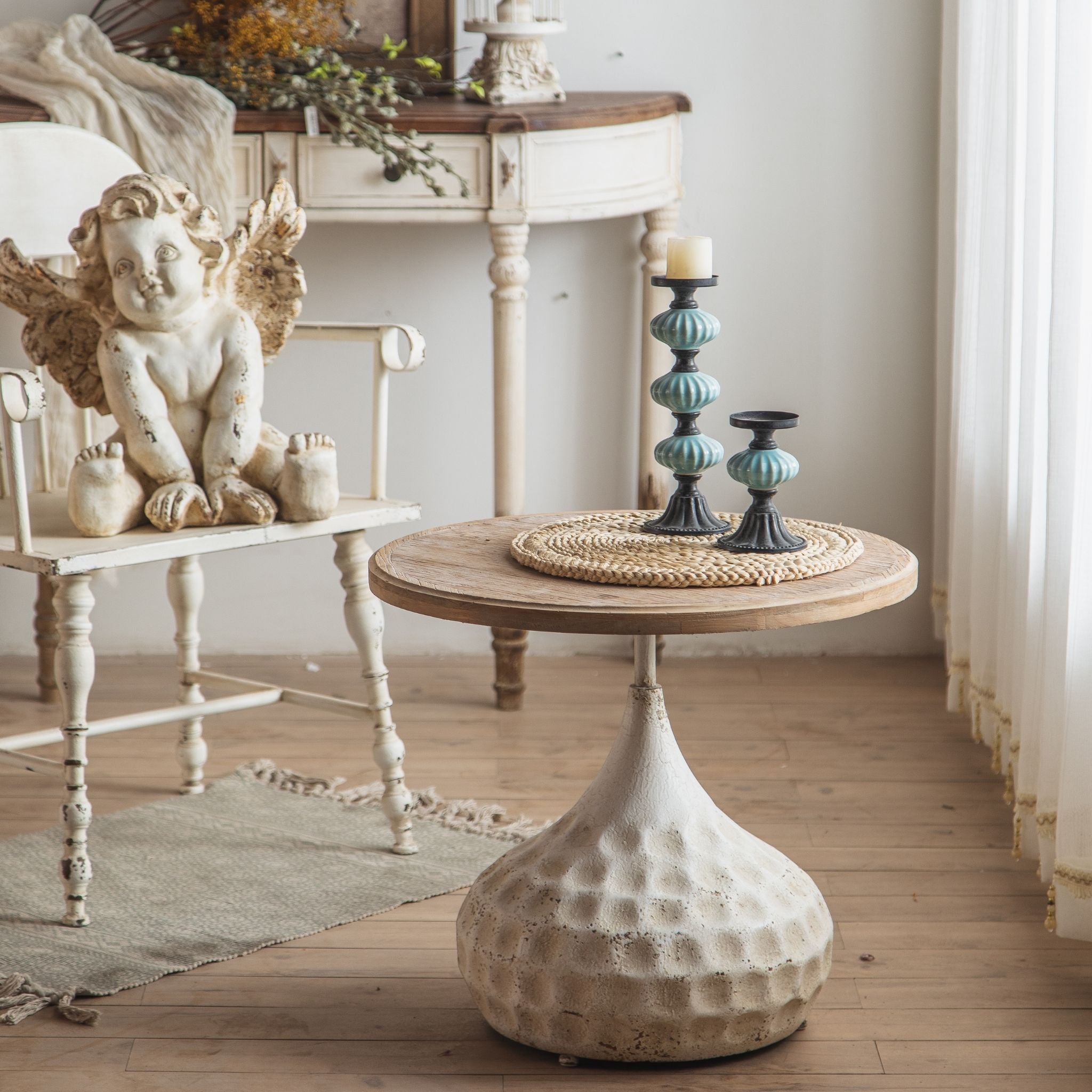 Tullia side table in a full room scene with cherub decor