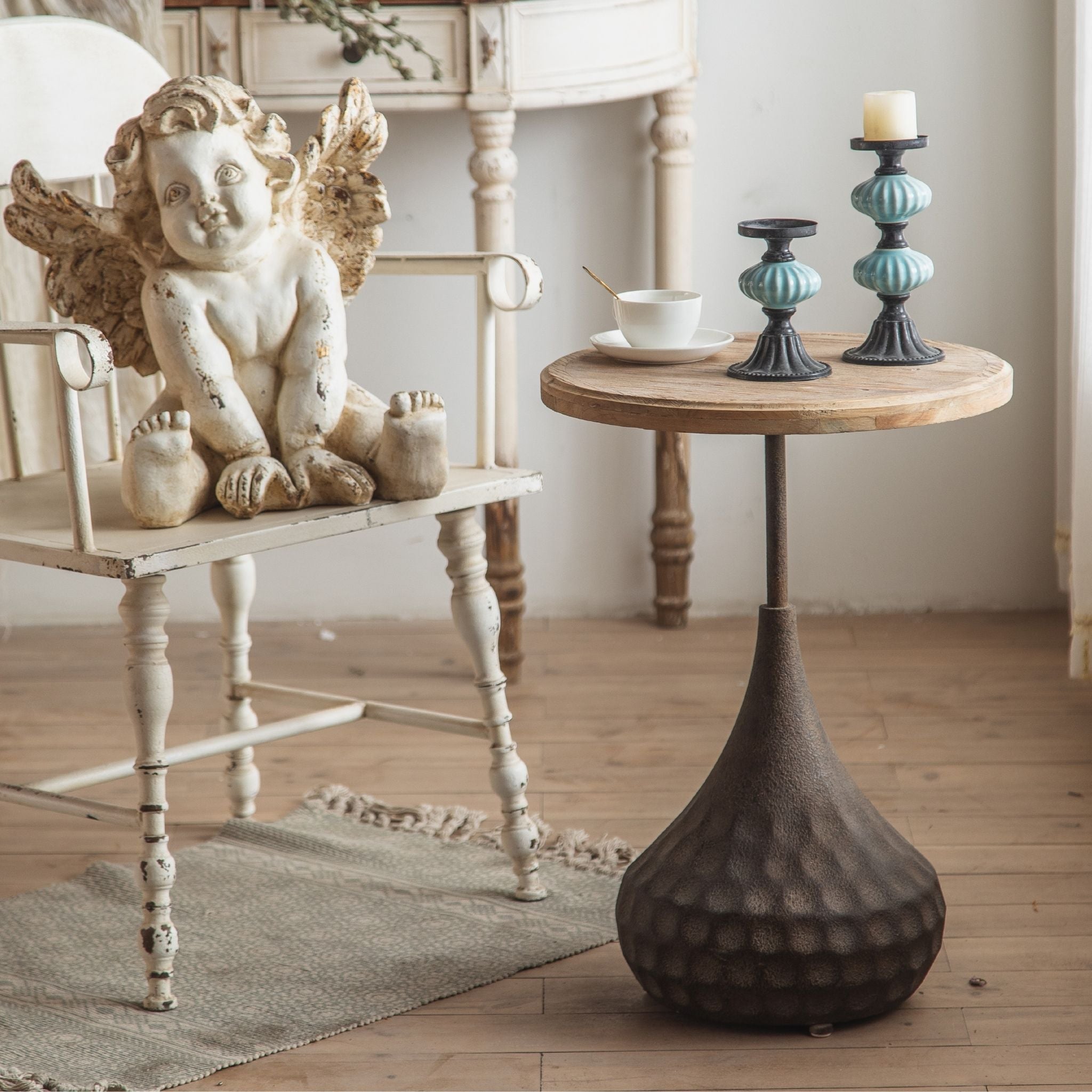 Vanna tall side table with fir top and hammered black teardrop base by a window