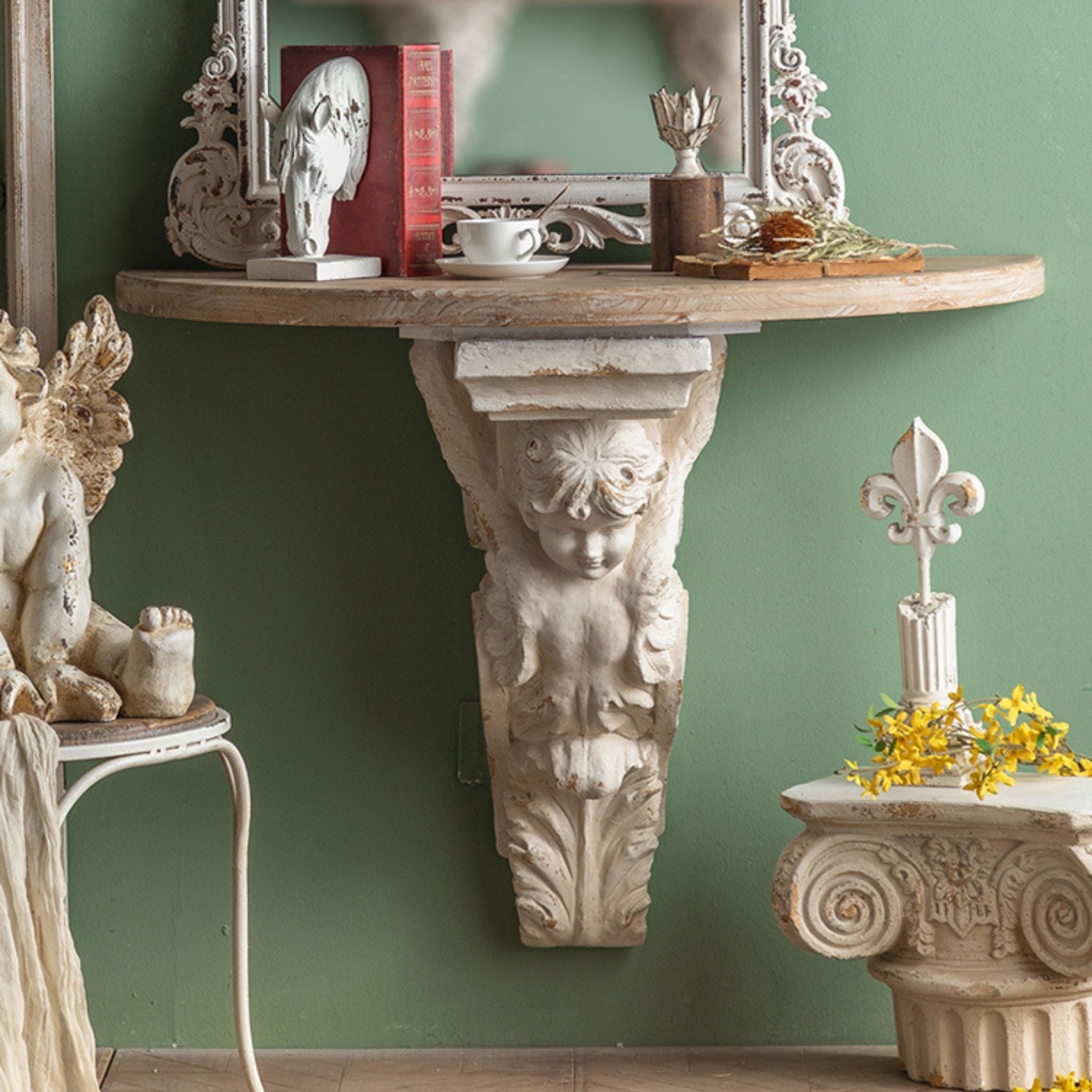 Ornella cherub corbel close up in aged white beneath the fir top