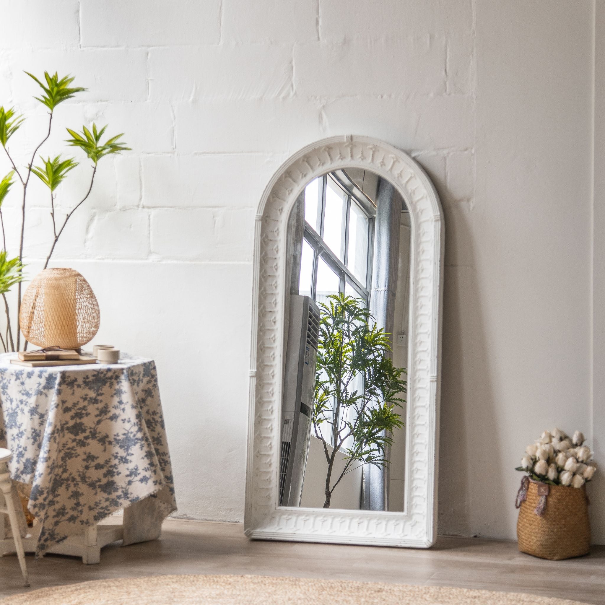Detail of the pressed frame ornament and worn white finish on the Theron mirror