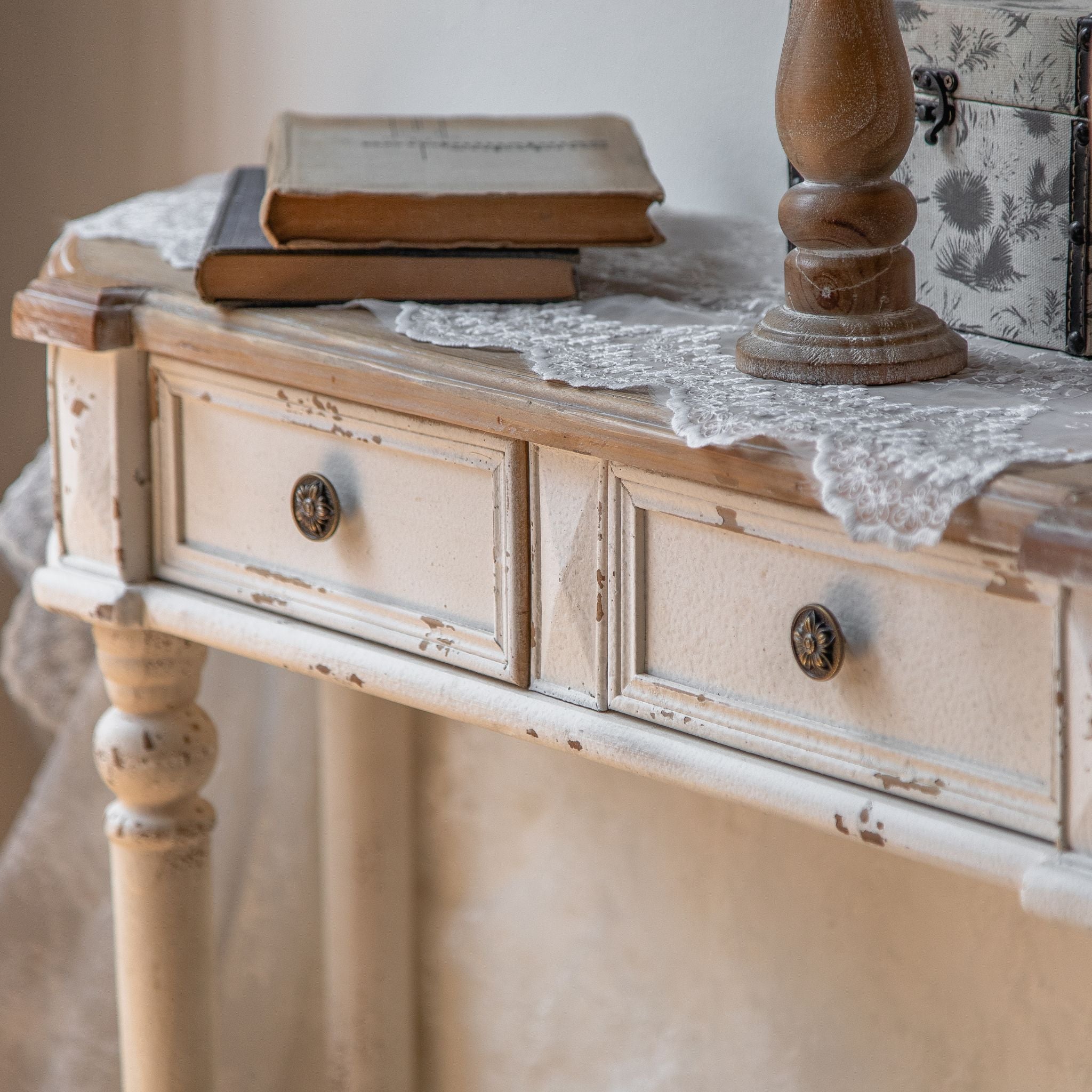 Close view of the chipped white finish and turned leg on the Talia console