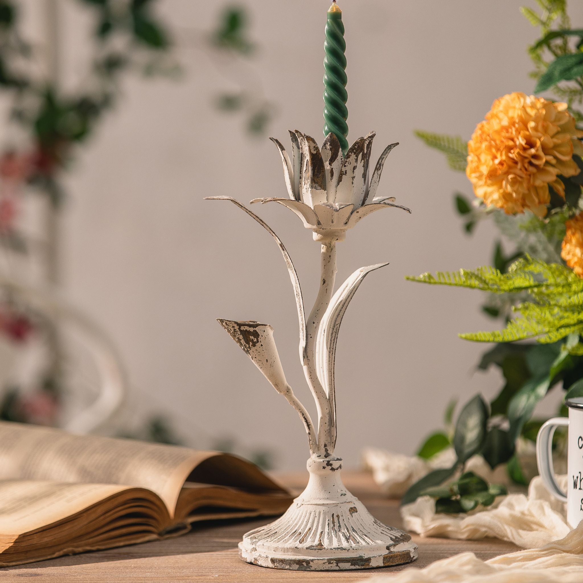 Detail of the fluted trumpet base and worn white finish on the Silvio candle holder