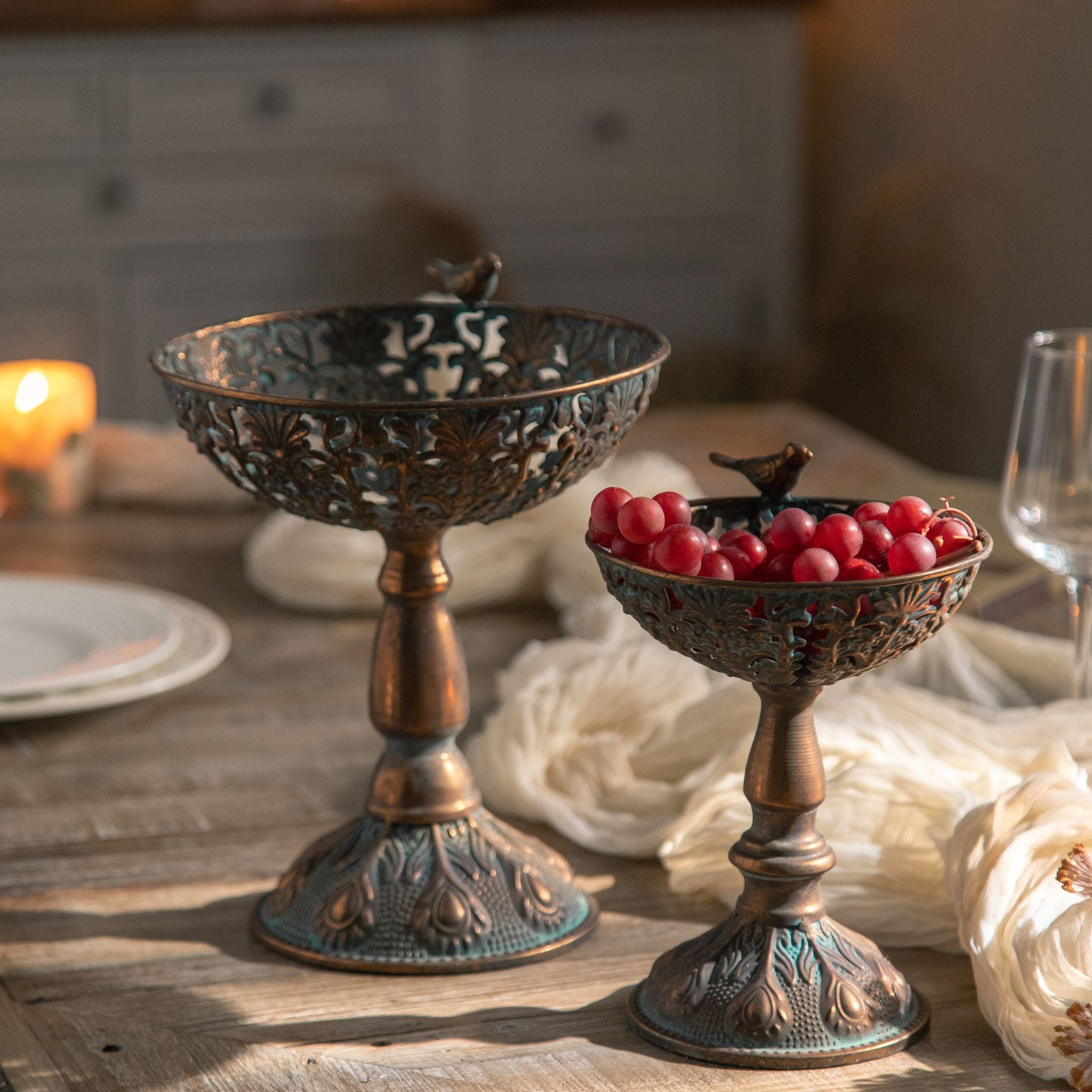 Close view of the pierced filigree bowl and verdigris patina on the Zeno pedestal bowl