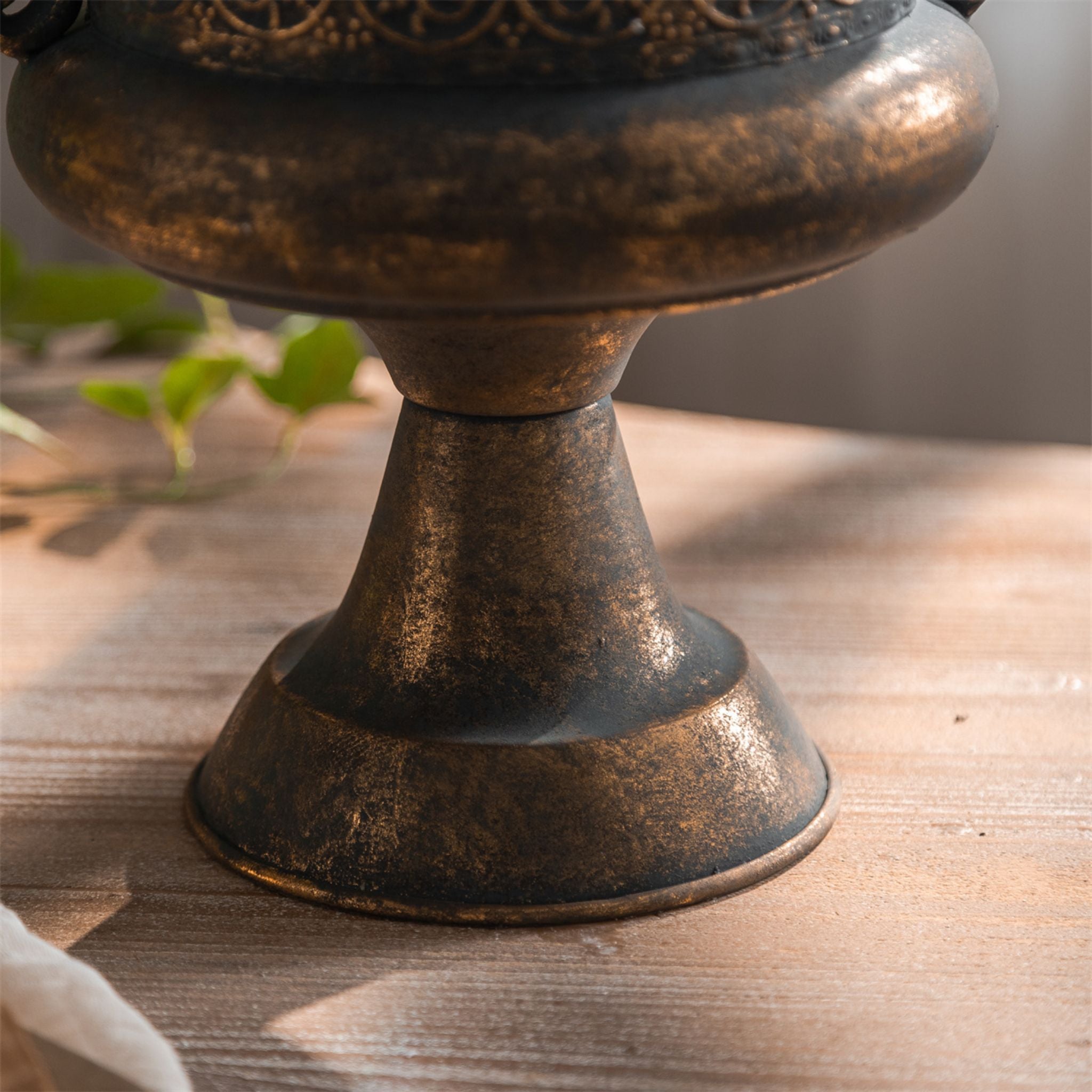 Amalfi bronze finish urn planter styled with greenery in a light room