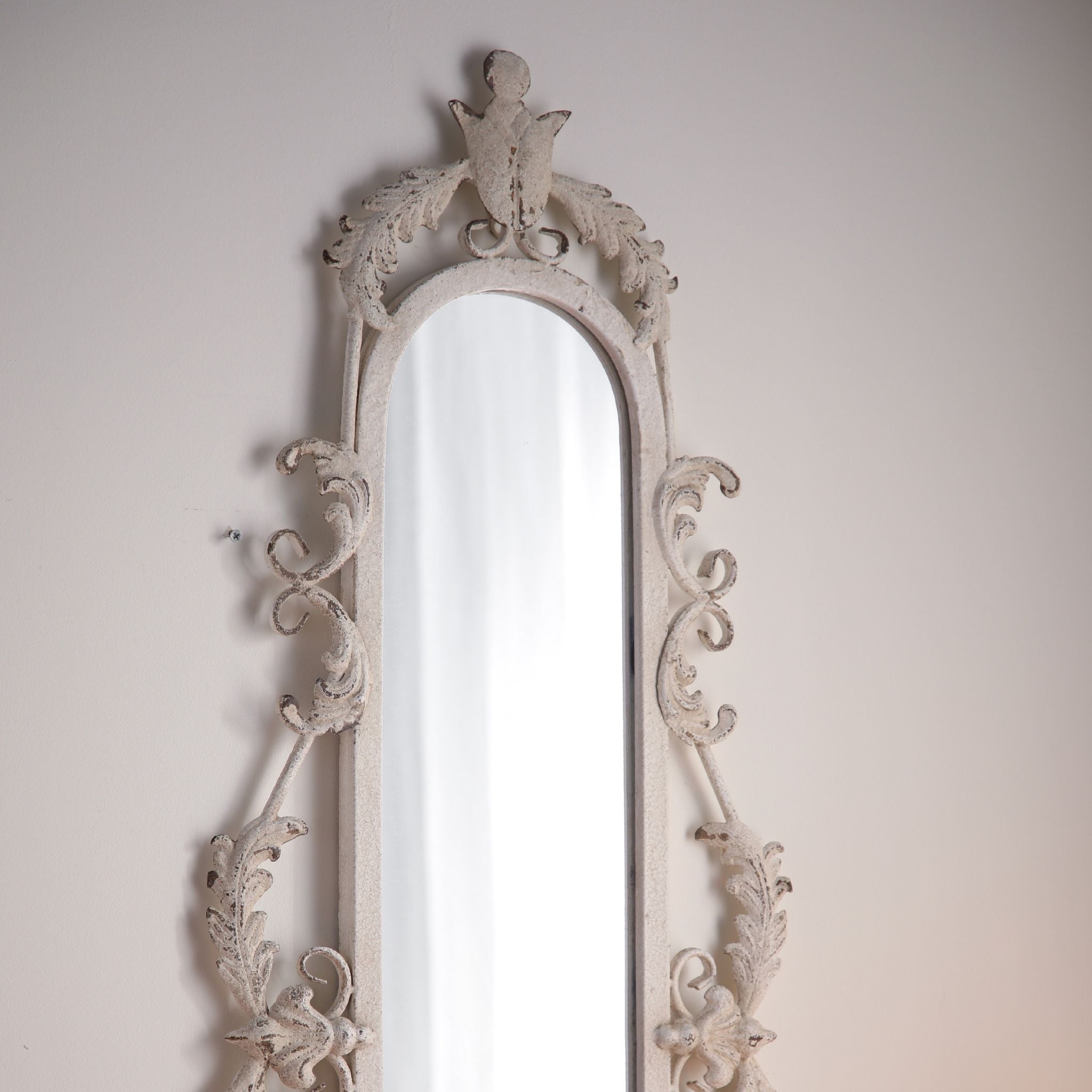 Detail of the leaf garland and bell drop at the base of the Pilar mirror