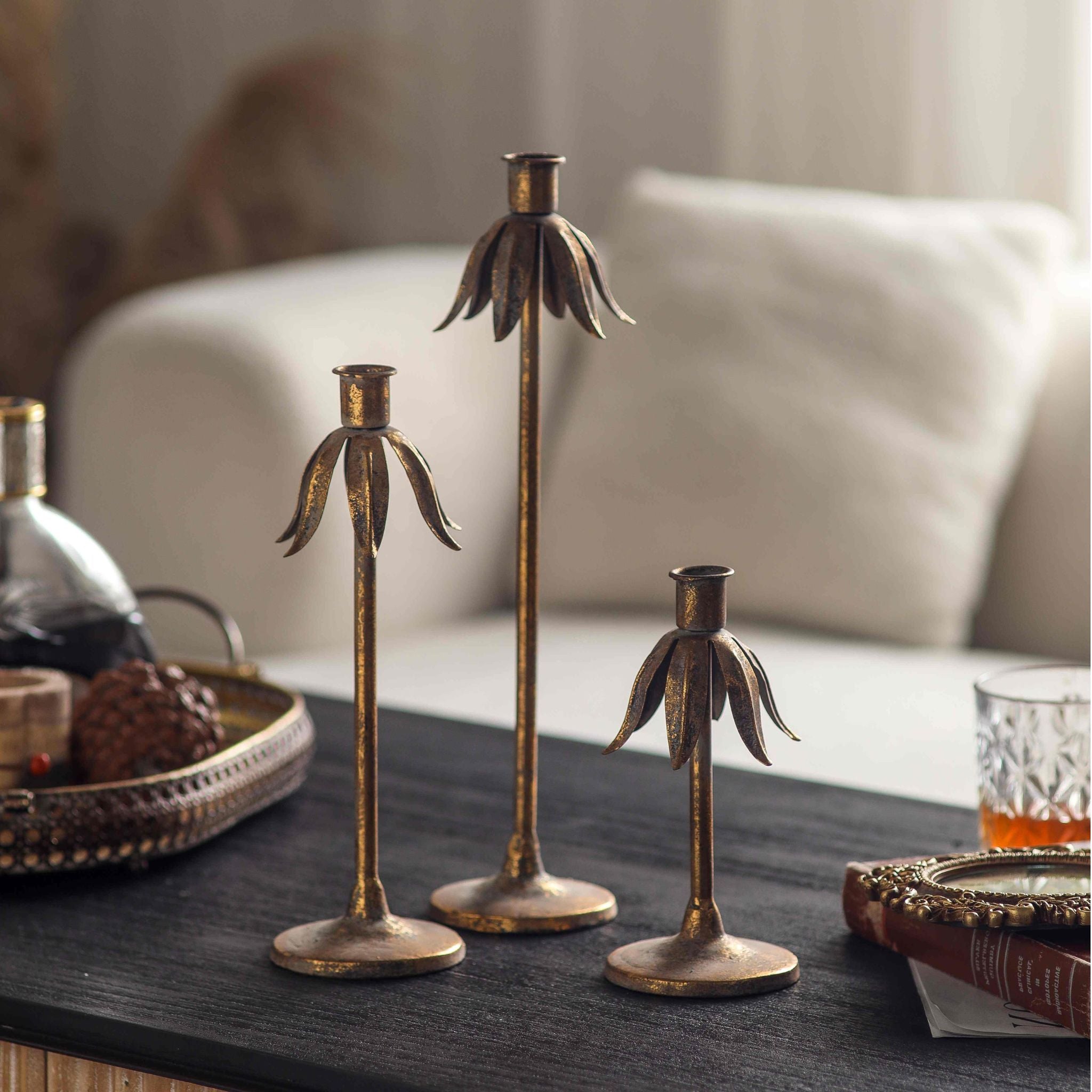 Detail of the slender stem and round foot with aged gold finish on the Ines holder