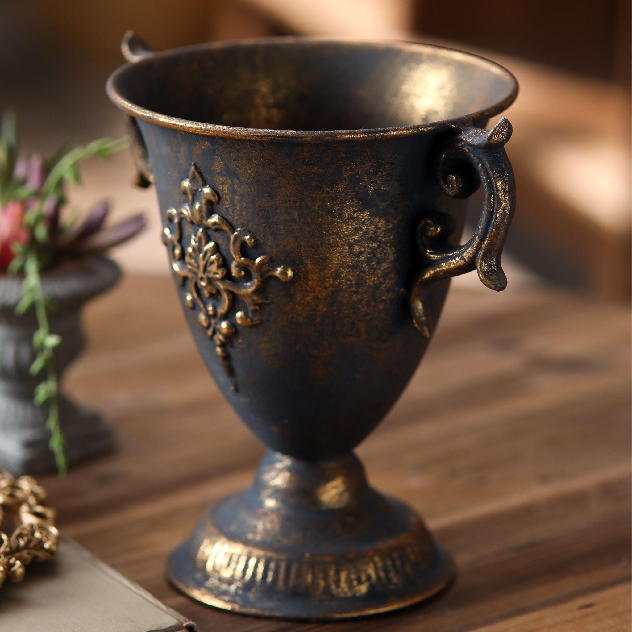 Close view of the raised damask medallion and gold dusting on the Isla urn