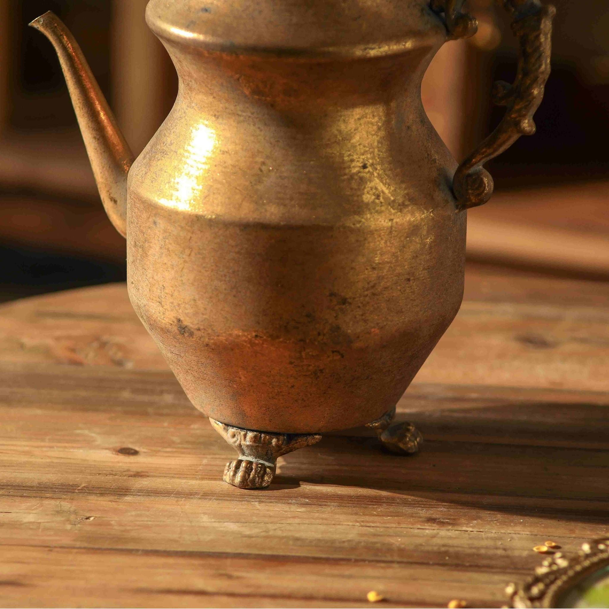 Close view of the ornate scroll handle and small feet on the Ivo teapot vase
