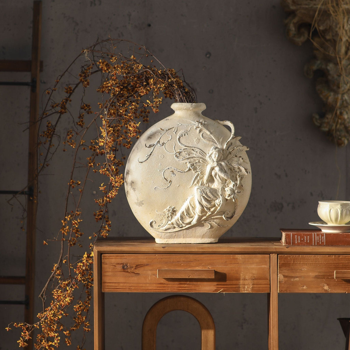 Mélusine French Provincial fairy moon flask vase in antique white magnesia on a timber console, raised fairy and flowering vine relief, 37cm