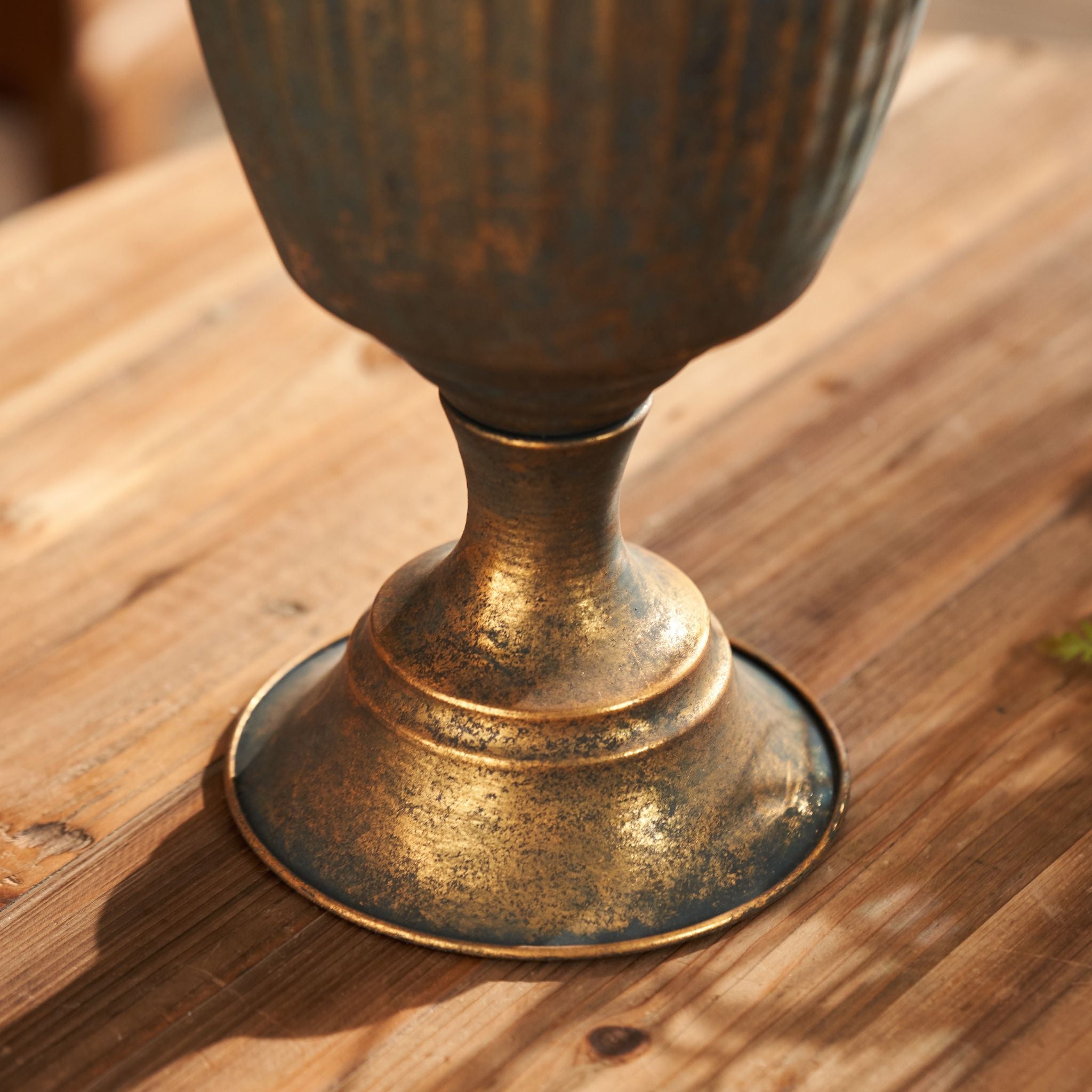 Close view of the pressed daisy lace band and scroll handle on the Olympia urn