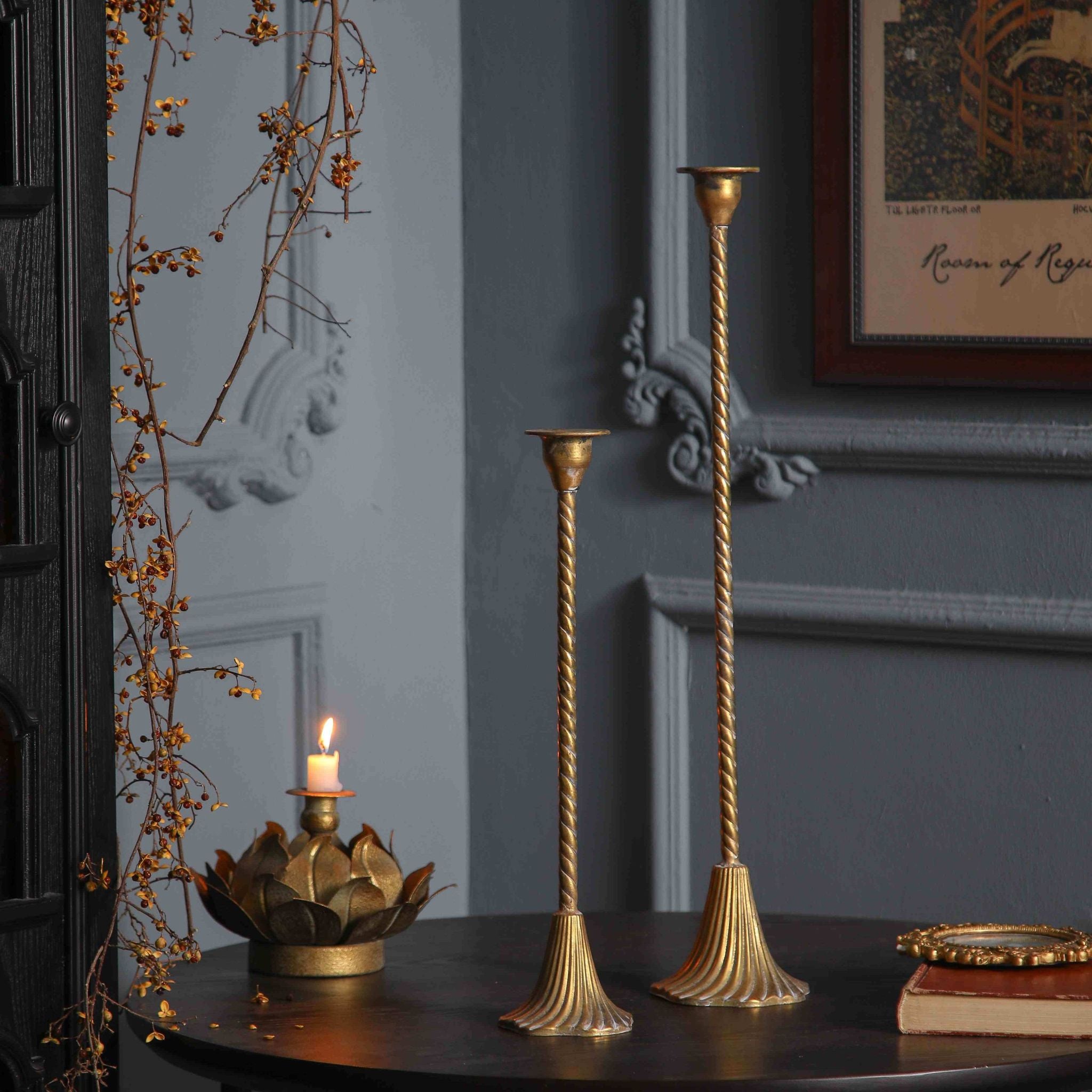 The Alma and Amara candlestick pair with white tapers in a panelled grey room