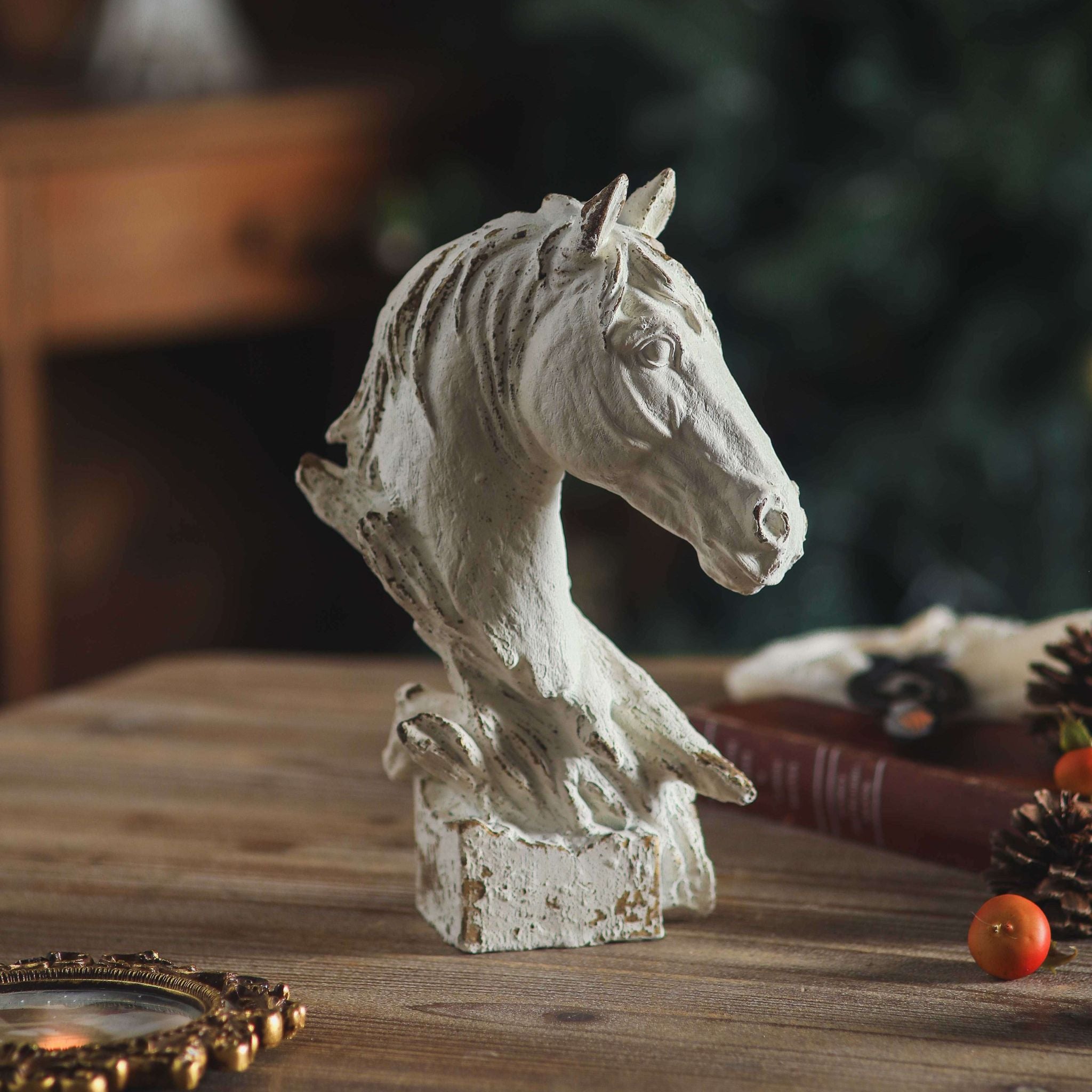 Cosimo horse head bust in distressed white on a timber table with old books