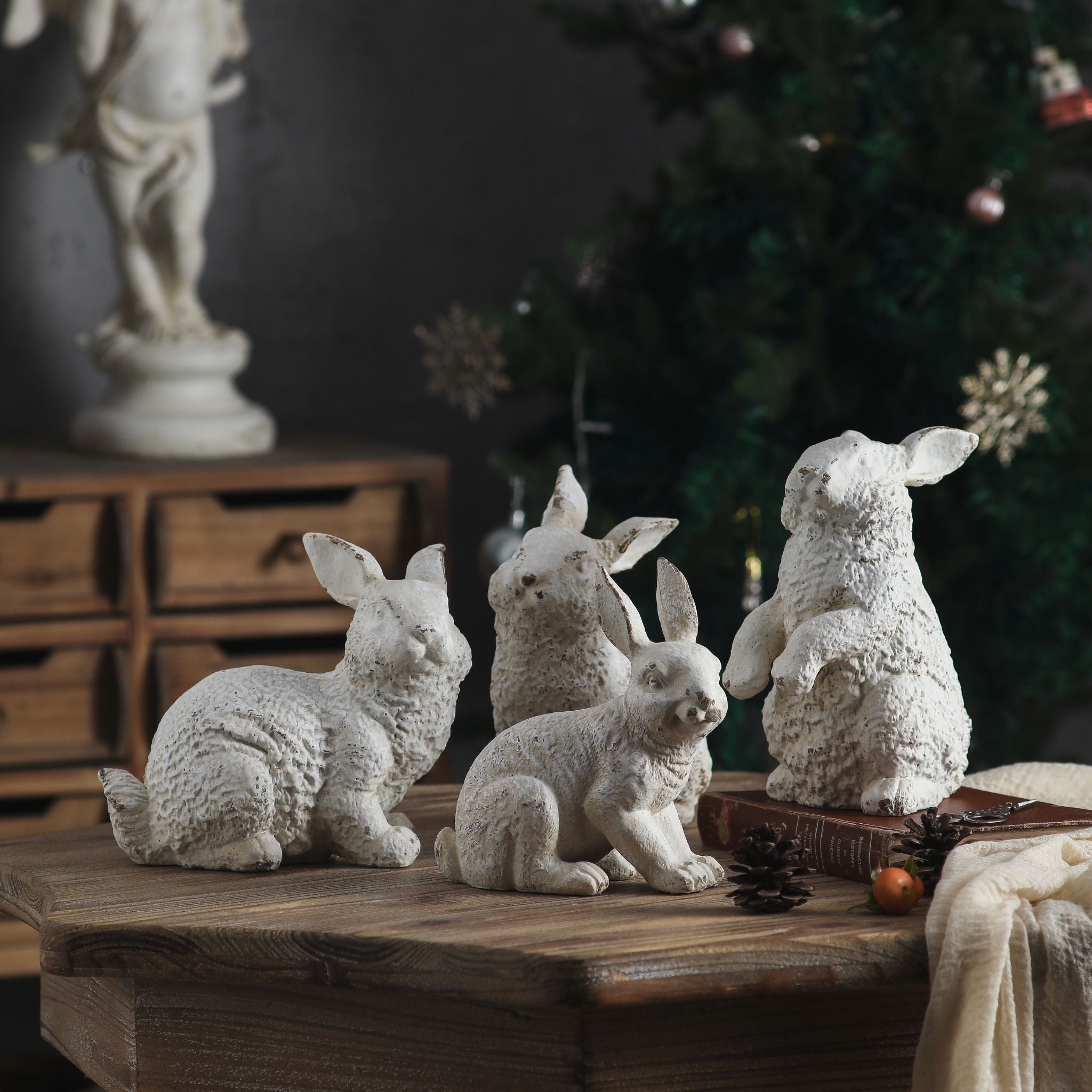 Delos sitting rabbit sculpture in aged white shown beside another rabbit figure
