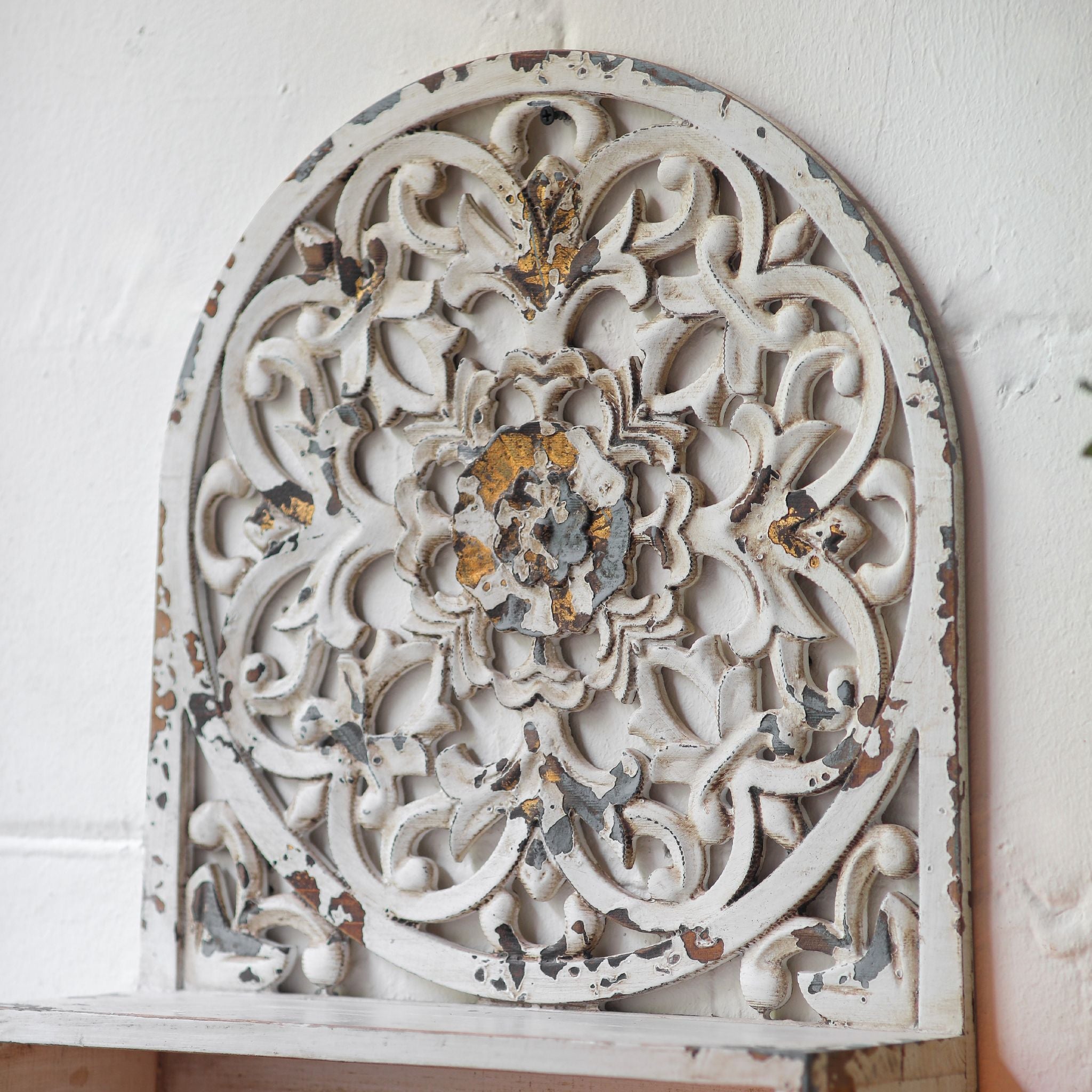 Detail of the Dimitri wall shelf ledge and antique brass finished hooks