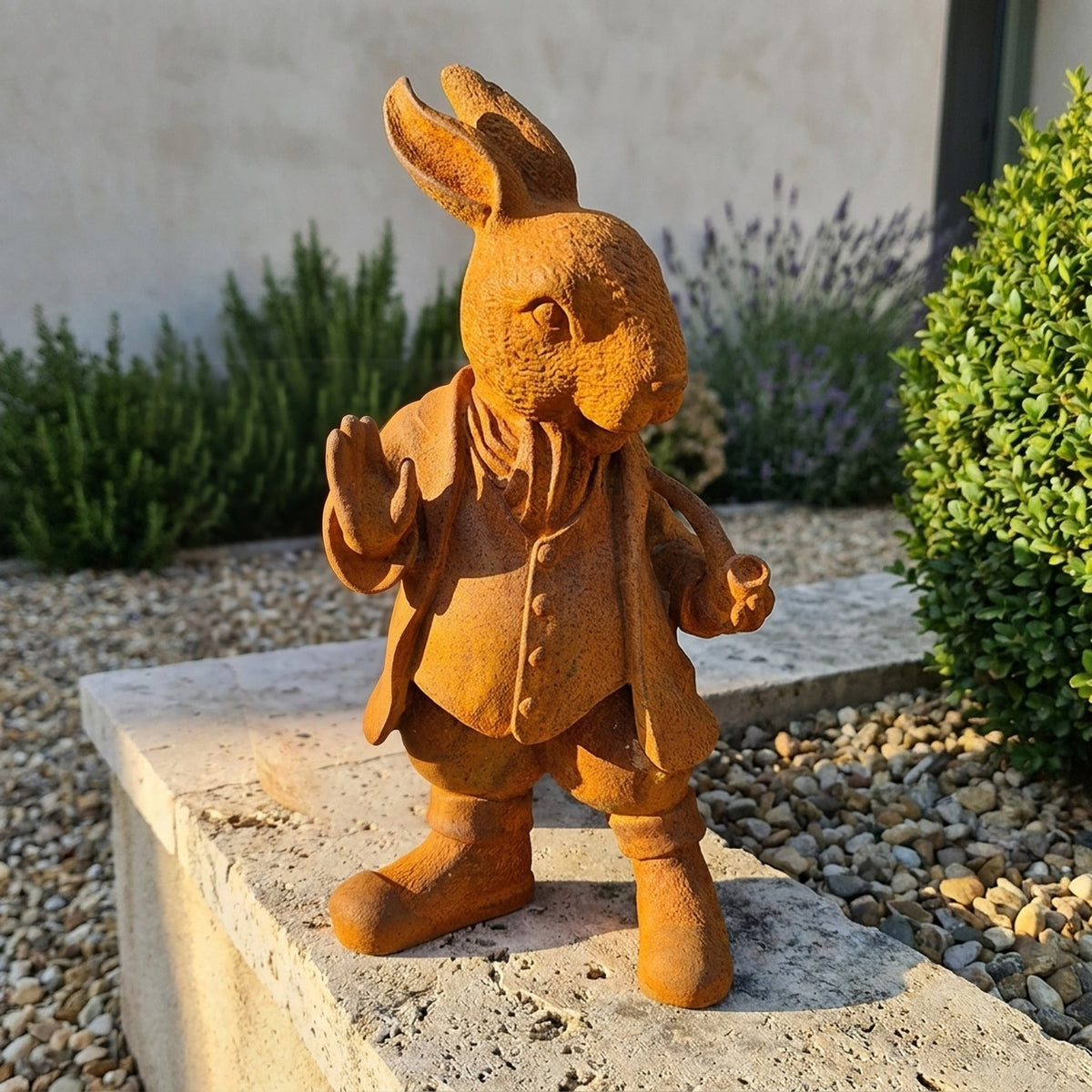Mayor Cottontail rust cast iron rabbit statue in a frock coat with a raised paw, on a travertine ledge