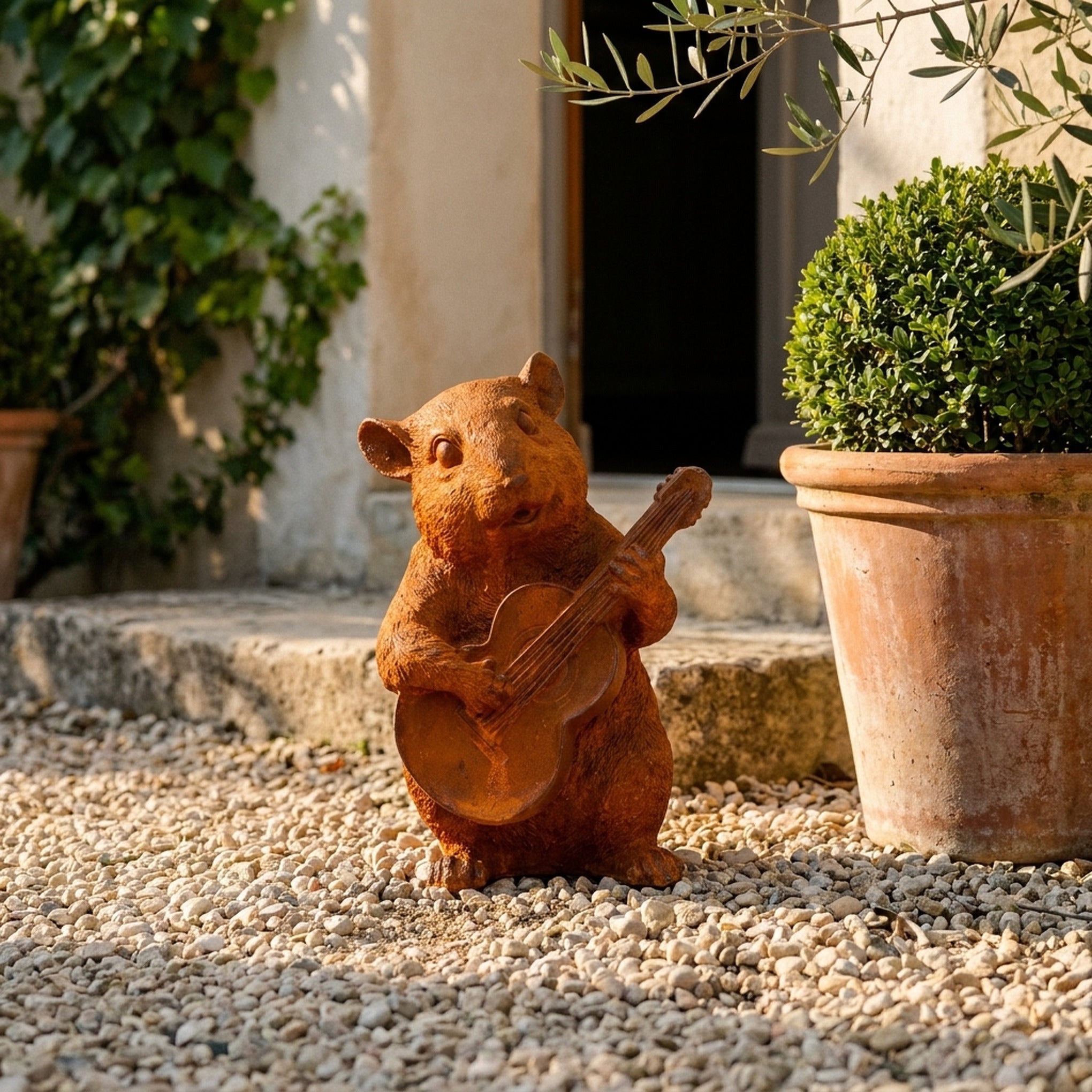 Bertie dormouse statue with a guitar three quarter view in a provencal courtyard