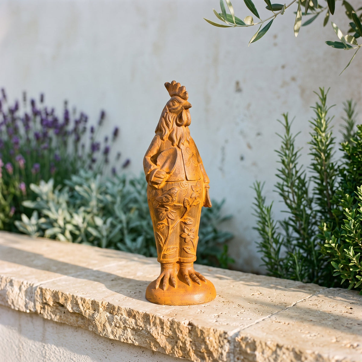 Mr Featherwick French Provincial cast iron rooster statue in a gardening jacket, three quarter view on a travertine ledge in a sunlit courtyard