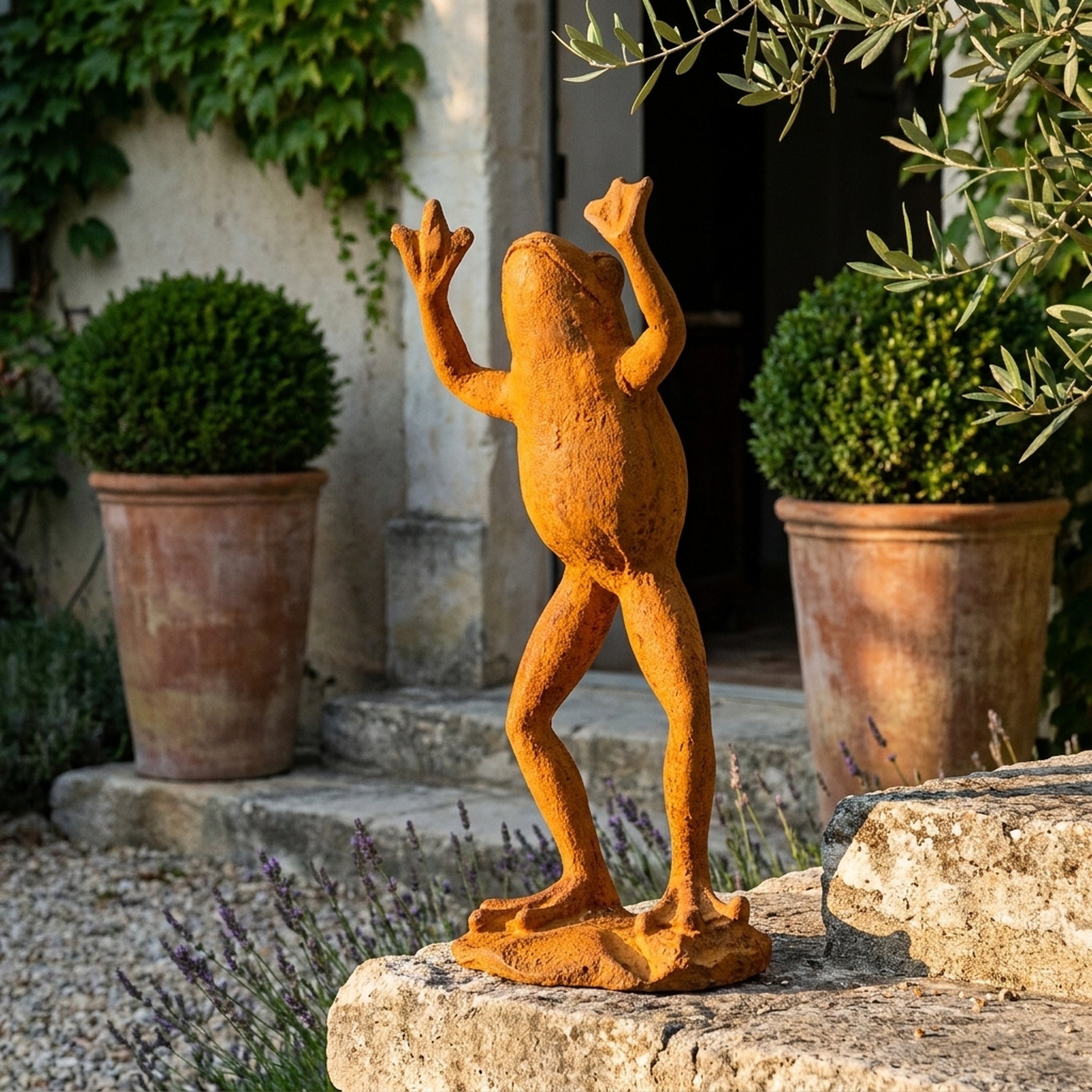 The Frog Prince rust cast iron frog statue three quarter view in a provencal courtyard