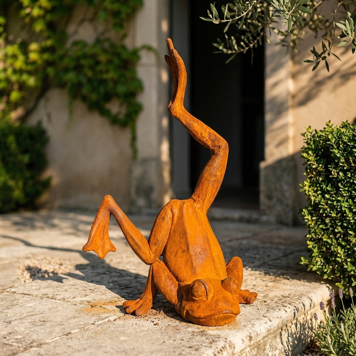 Major Ribbit handstand frog statue three quarter view in a provencal courtyard