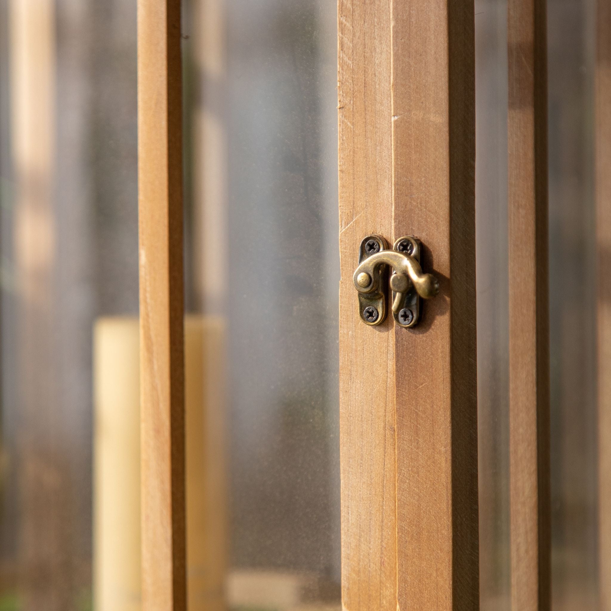 Close-up of the antique brass latch on the fir timber door