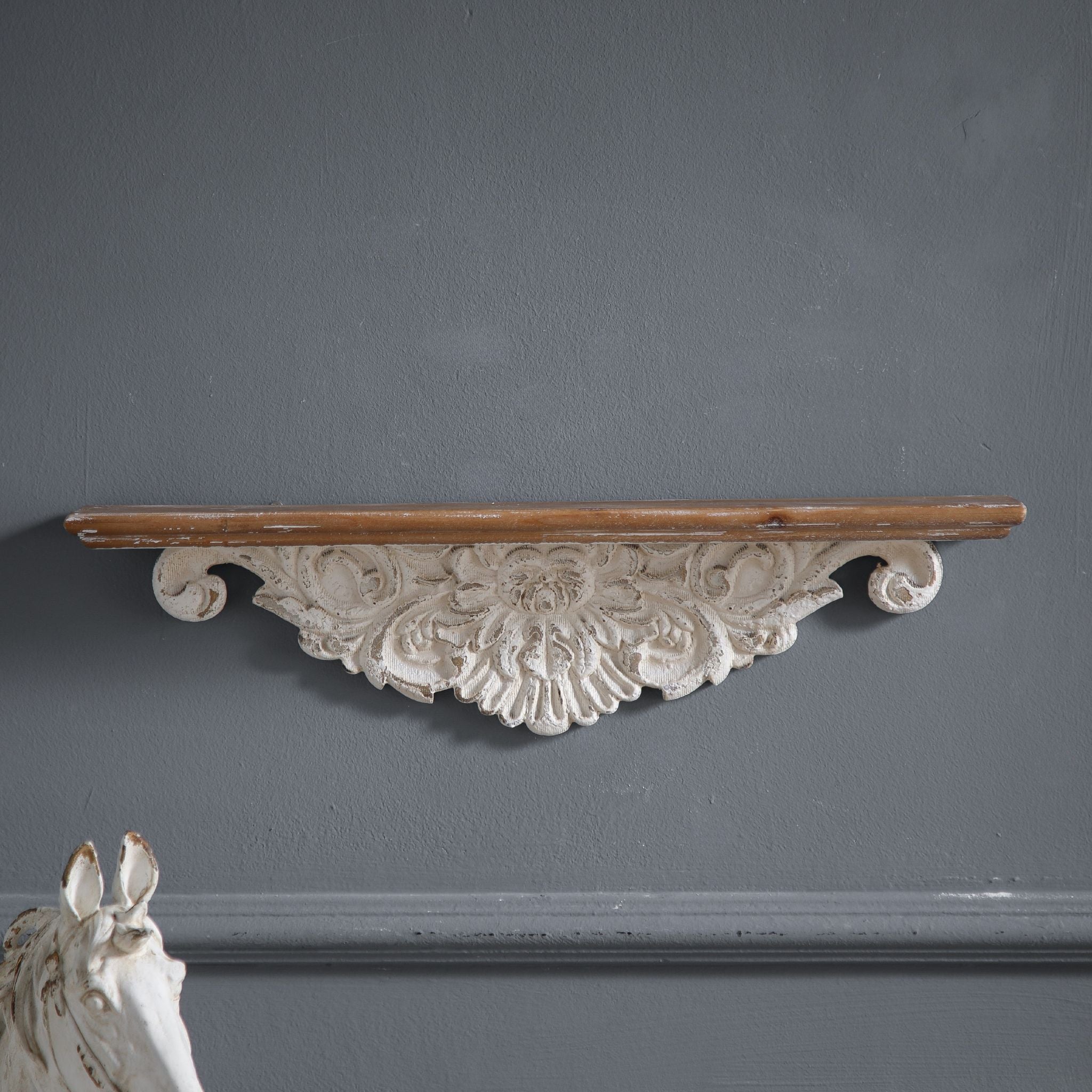 Front view of Jennifer wall ledge shelf solo on a charcoal wall, full piece visible with carved apron underneath the timber top