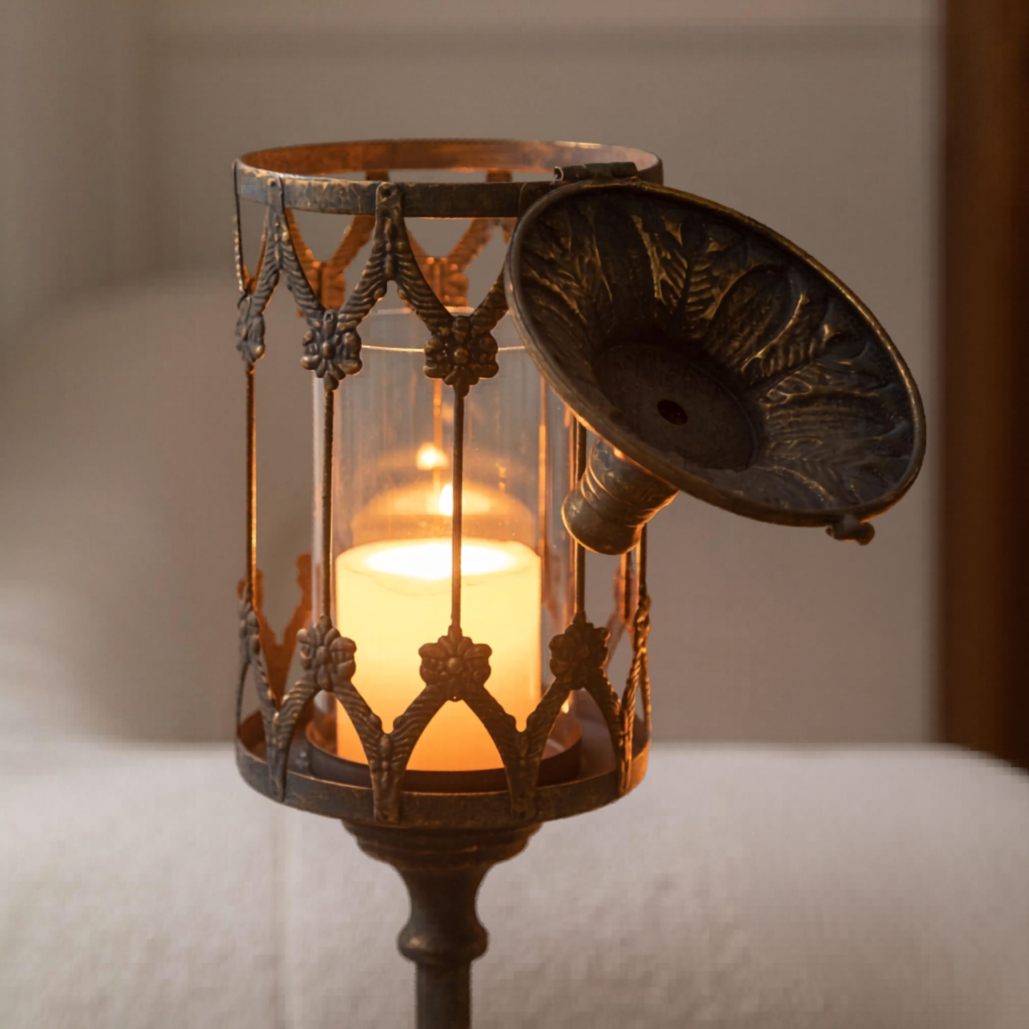 Hinged domed lid lifted open to place a pillar candle in the glass hurricane