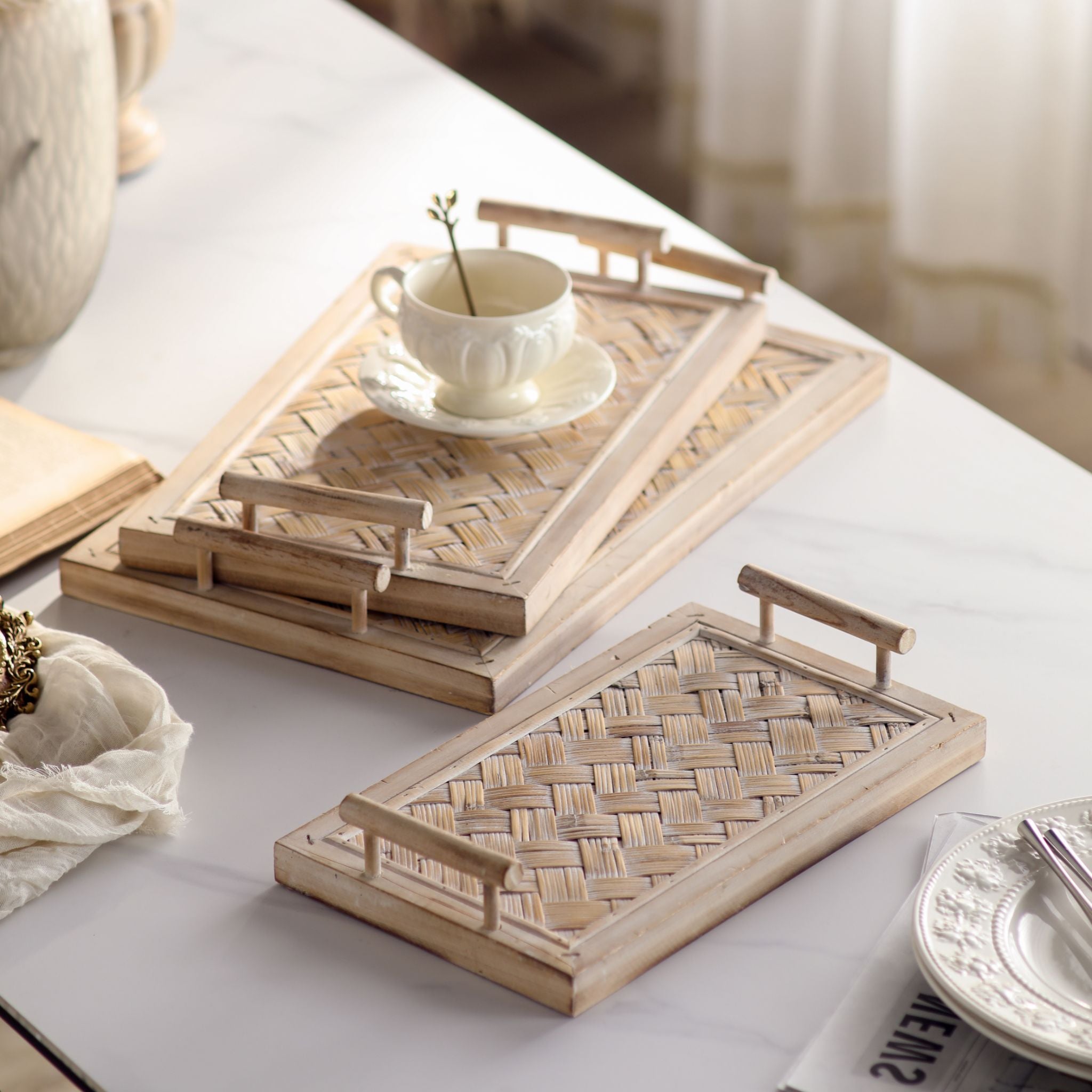 Lola French country tray set of 3 in whitewashed fir and woven bamboo styled with a teacup. Hero.