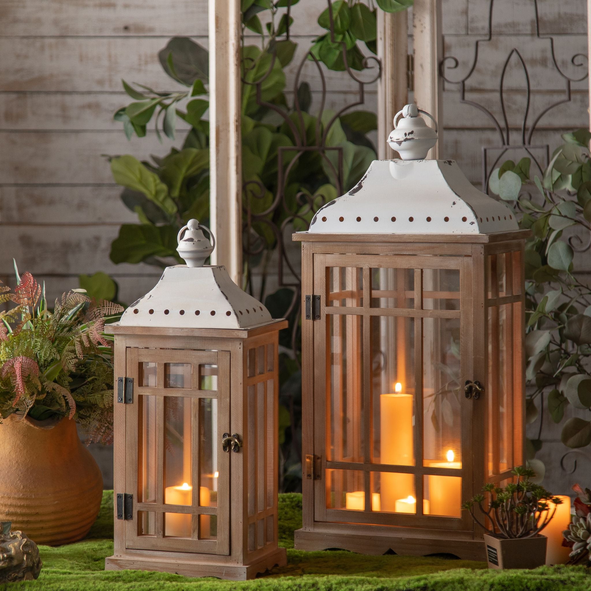 Richard set of two fir timber and glass lanterns with white metal roofs, lit