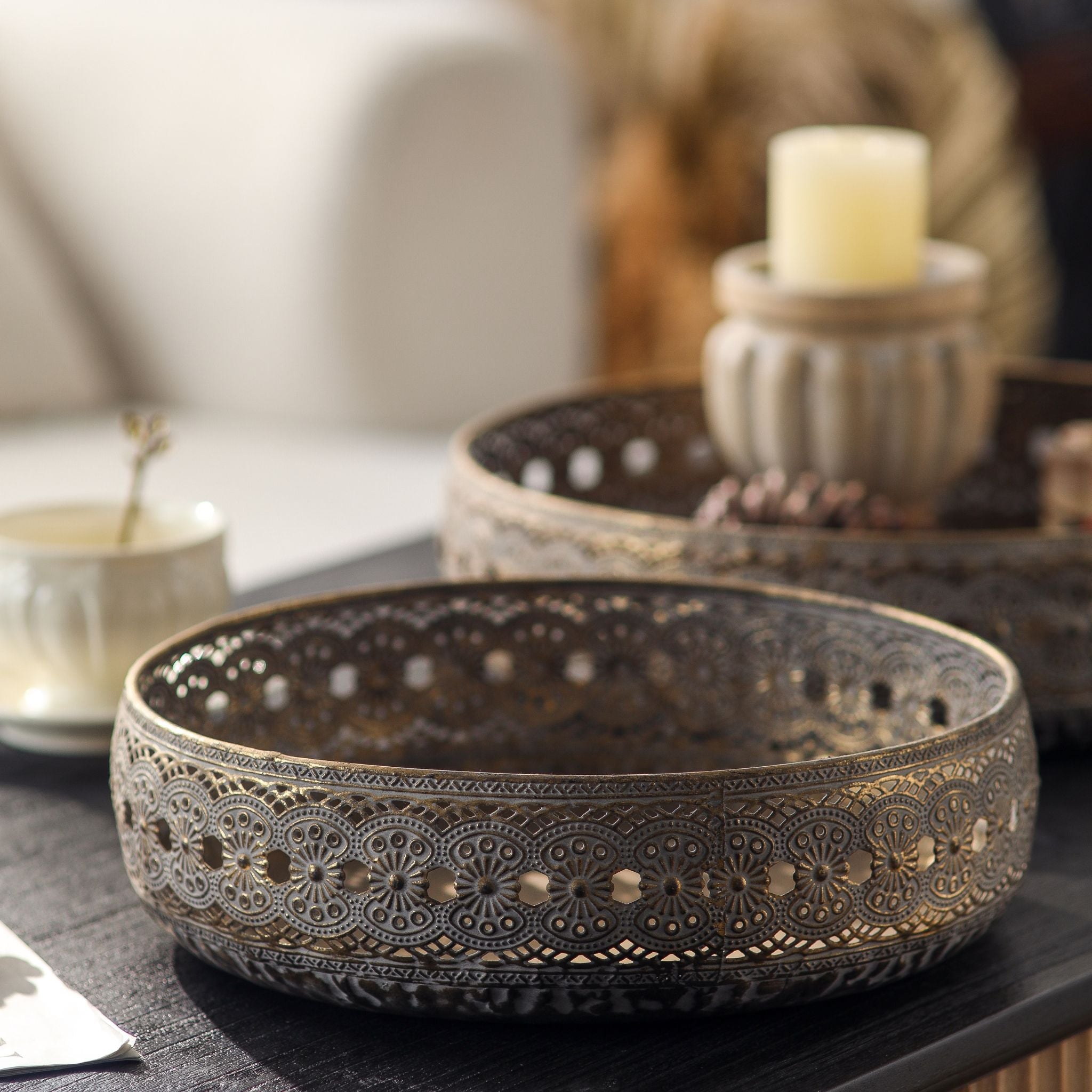 Abrielle metal trays shown as a nesting pair, the smaller bowl in front of the larger, antique gold lace-edged sides