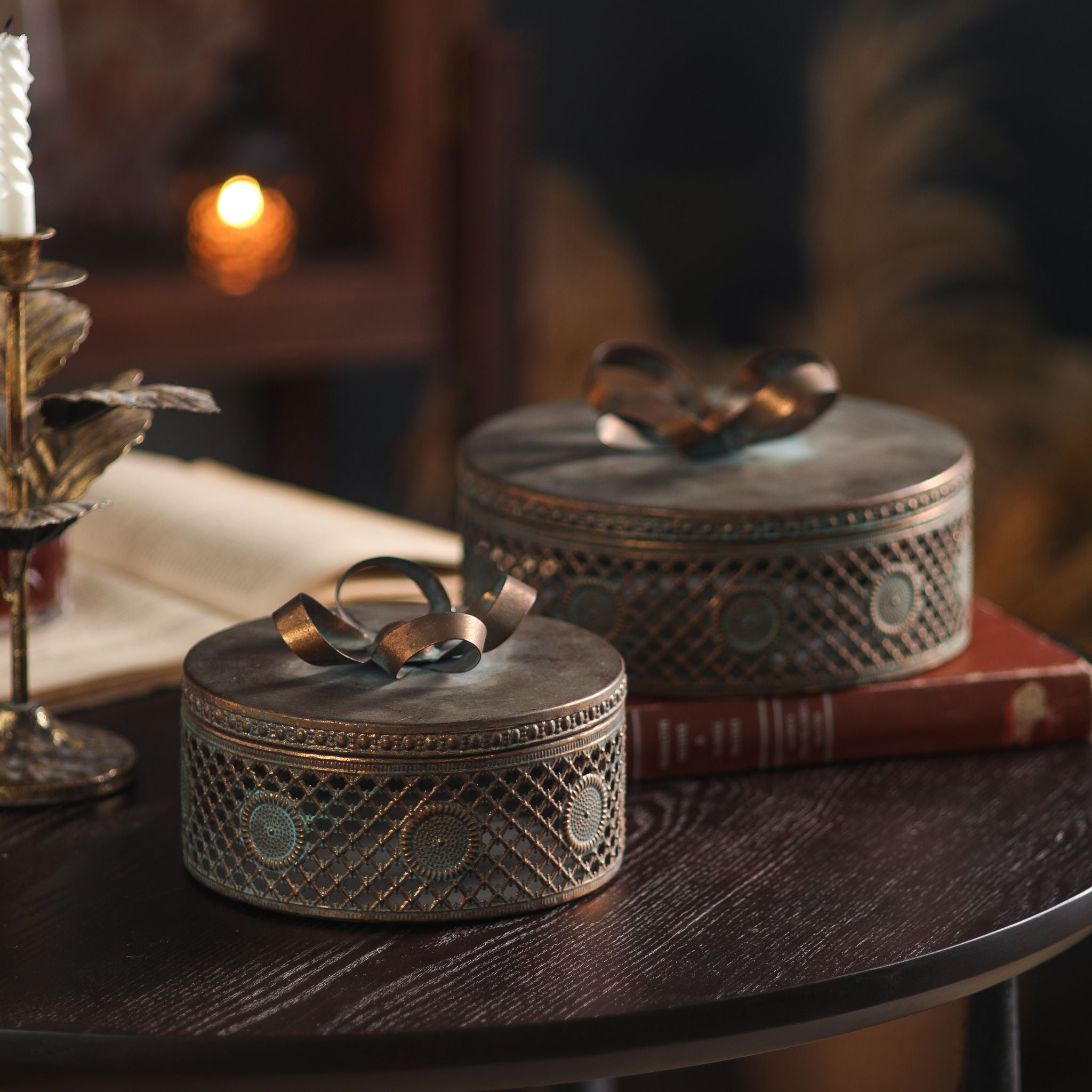 Alba set of two antique-bronze lidded trinket boxes with bow lids and pierced sides. Hero.