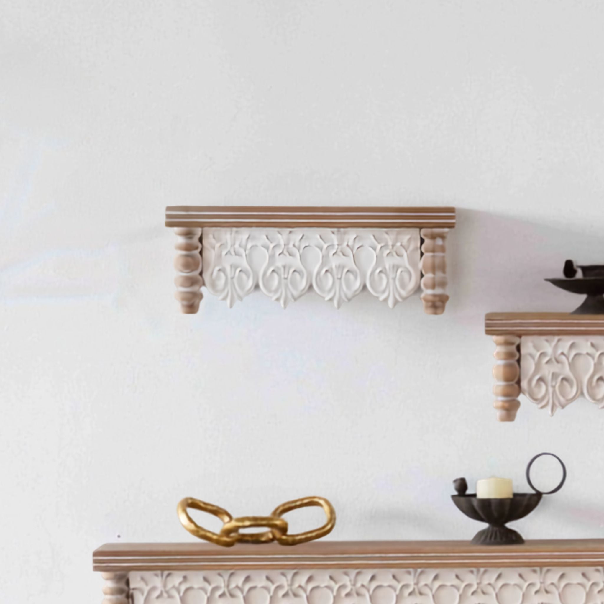 Audrey carved-apron wall shelf, the smallest size, mounted on a wall. Hero