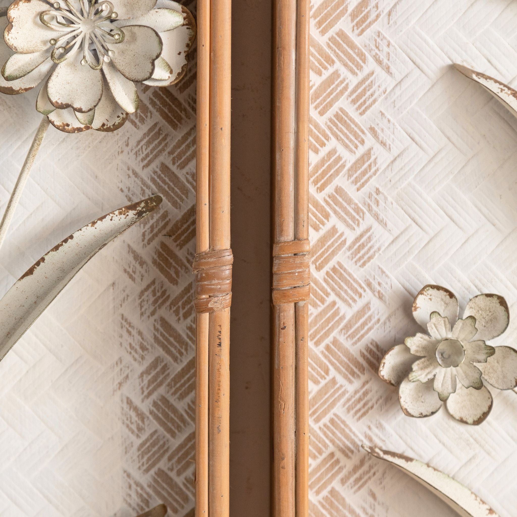 Detail of the raised metal leaves standing proud of the woven ground on the Aurélien panel.