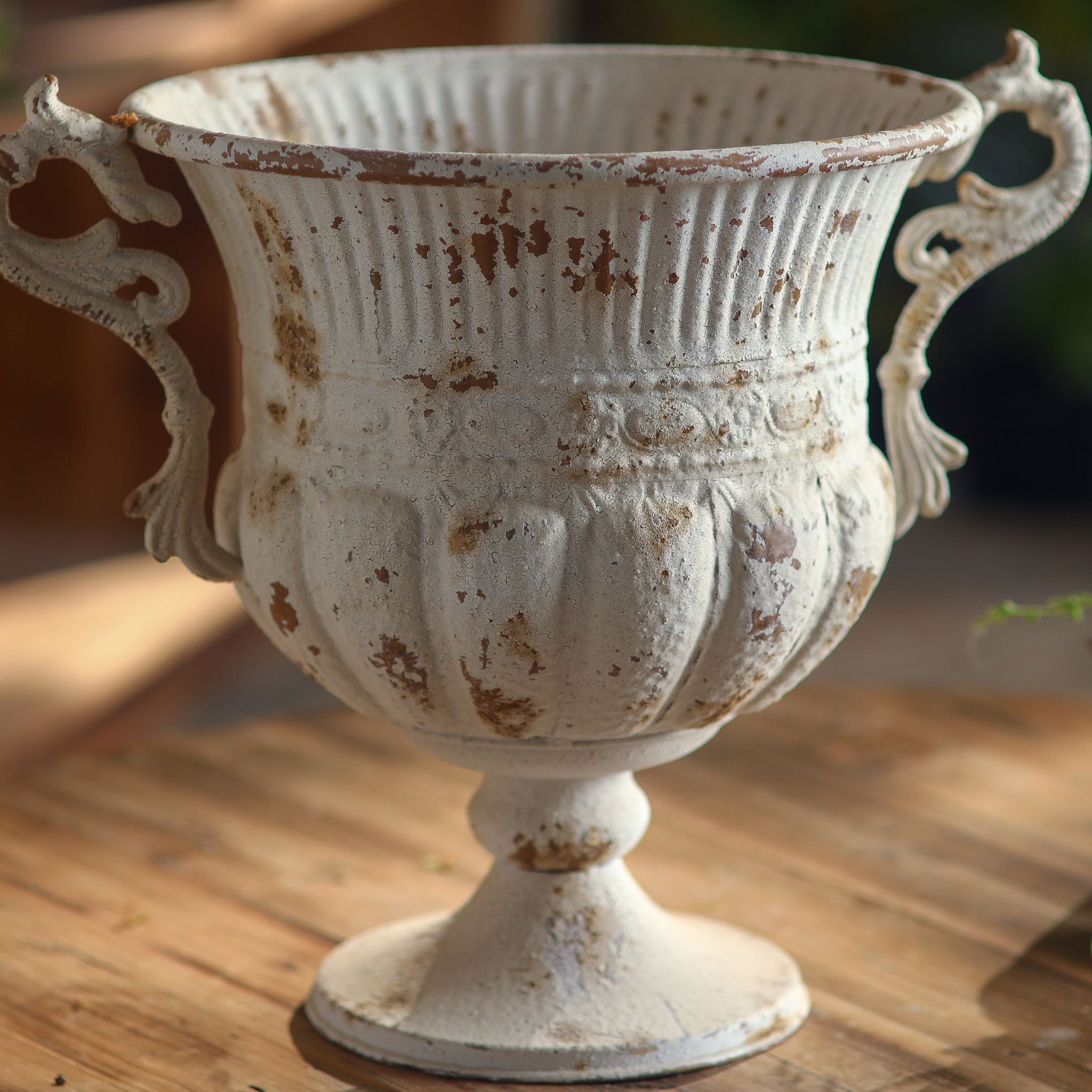 Benoît urn planter shown empty, twin scroll handles, fluted bowl and turned foot in distressed antique white metal.