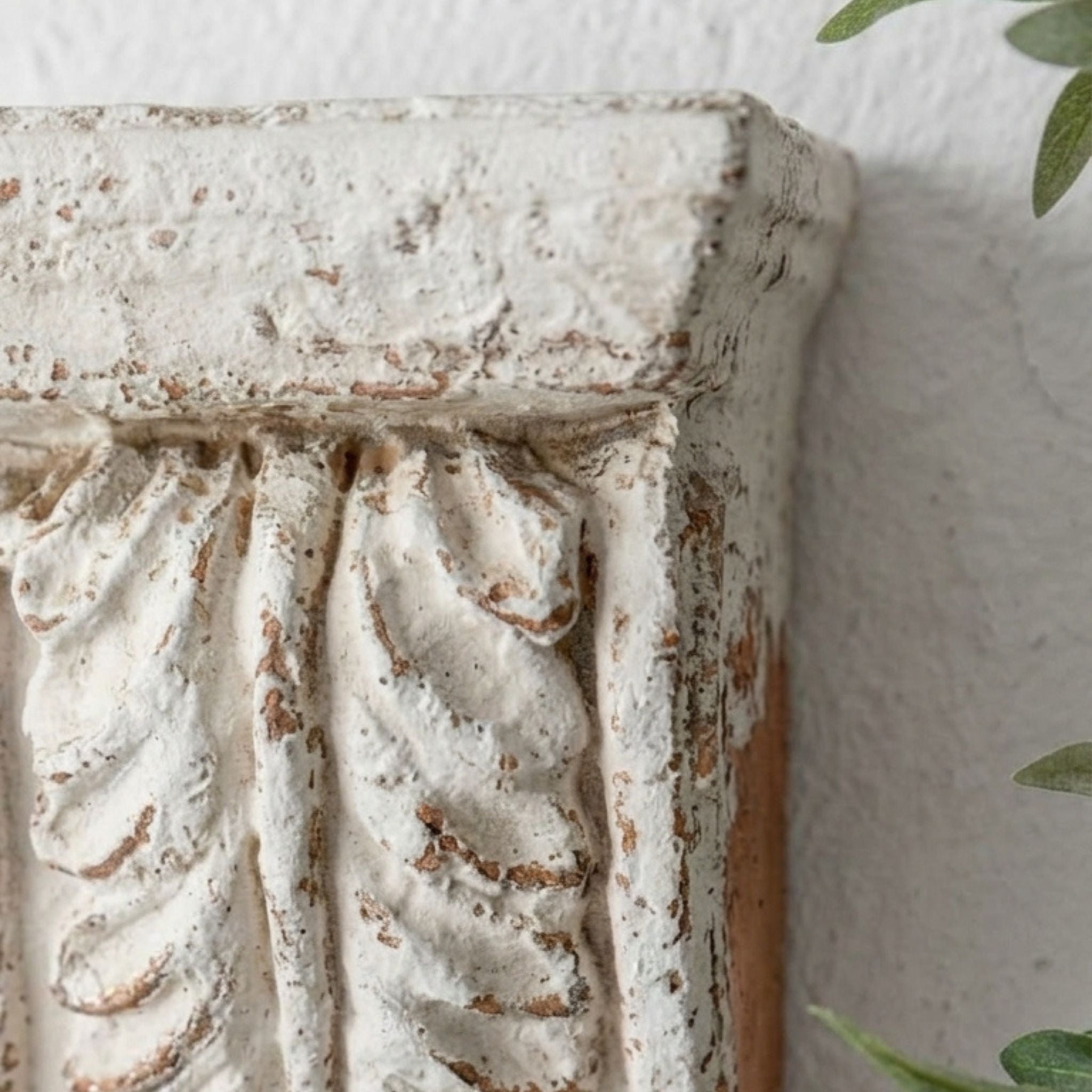 Brigitte corbel wall sconce close-up of the acanthus leaf relief and distressed finish