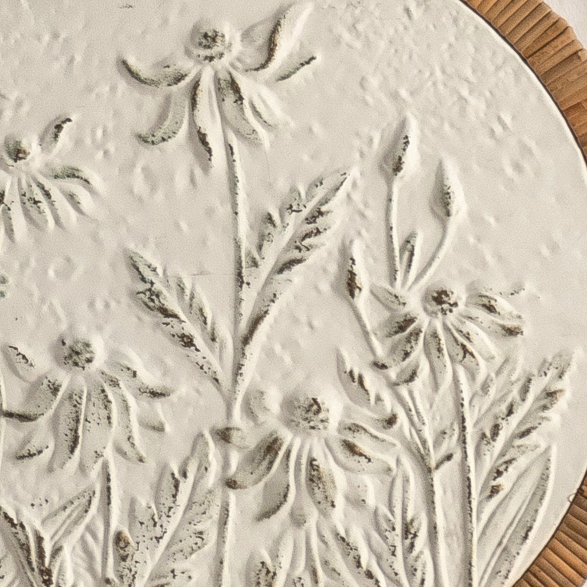 Detail of the embossed flower relief and the rattan-wrapped frame of the Calvin panel.