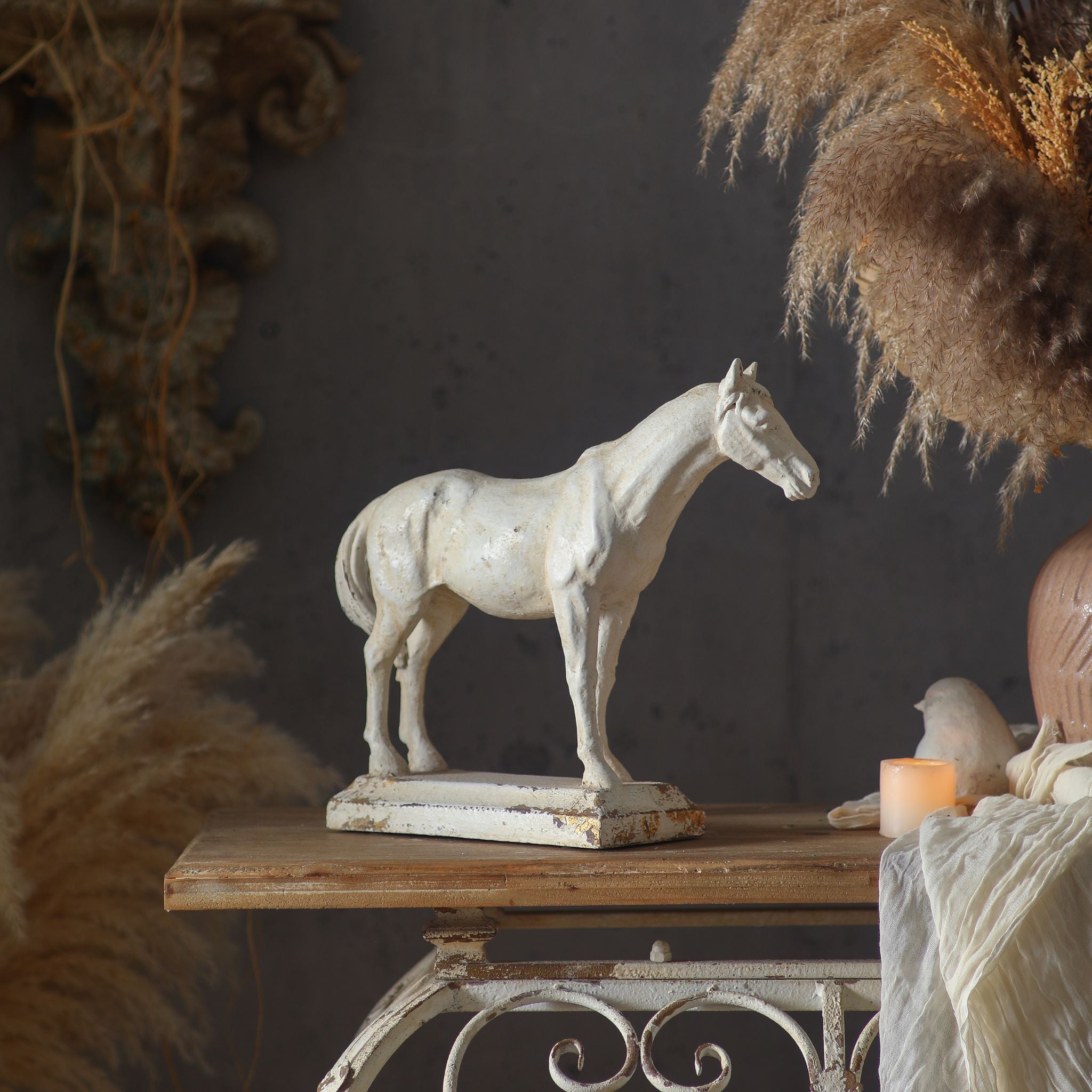 Alternate styled angle of the Camargue horse sculpture with pampas grass, dried florals and a pink ceramic vase