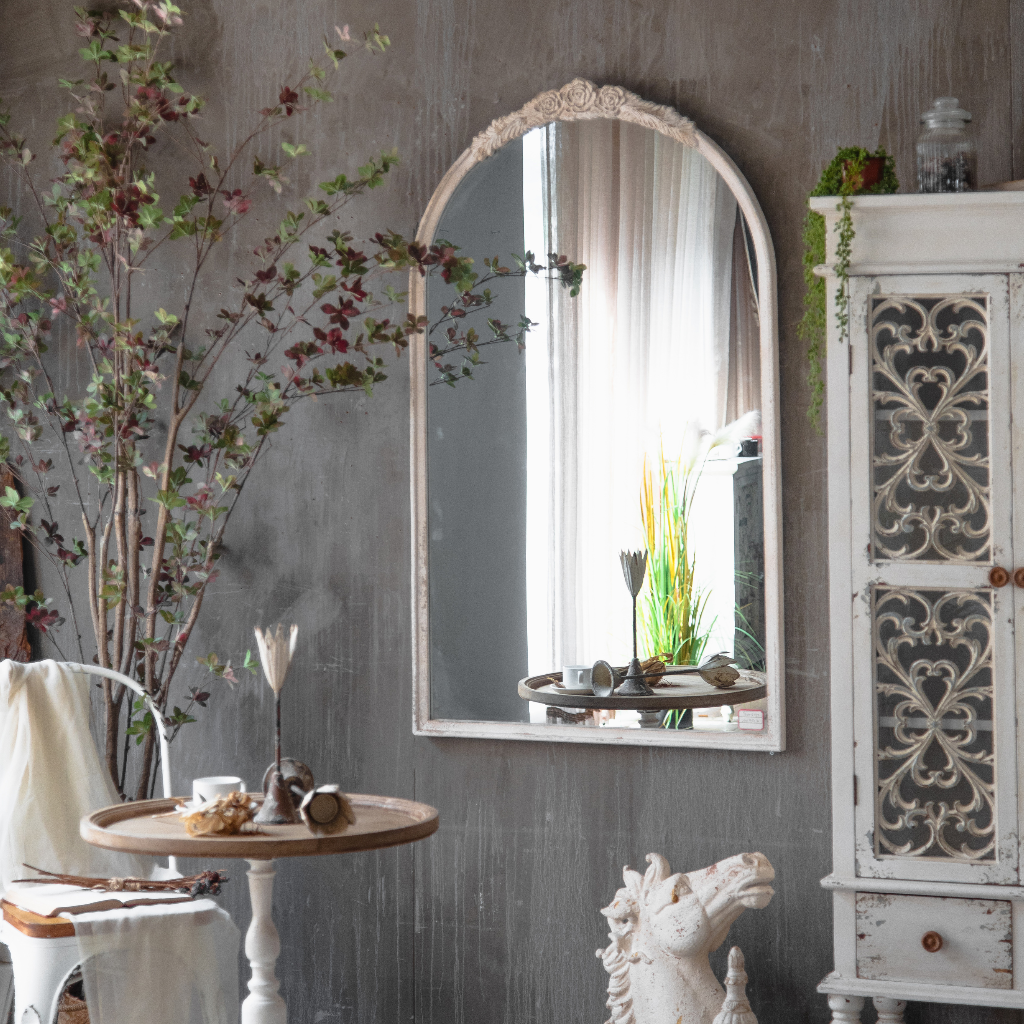Camille arched wall mirror styled in a French country interior
