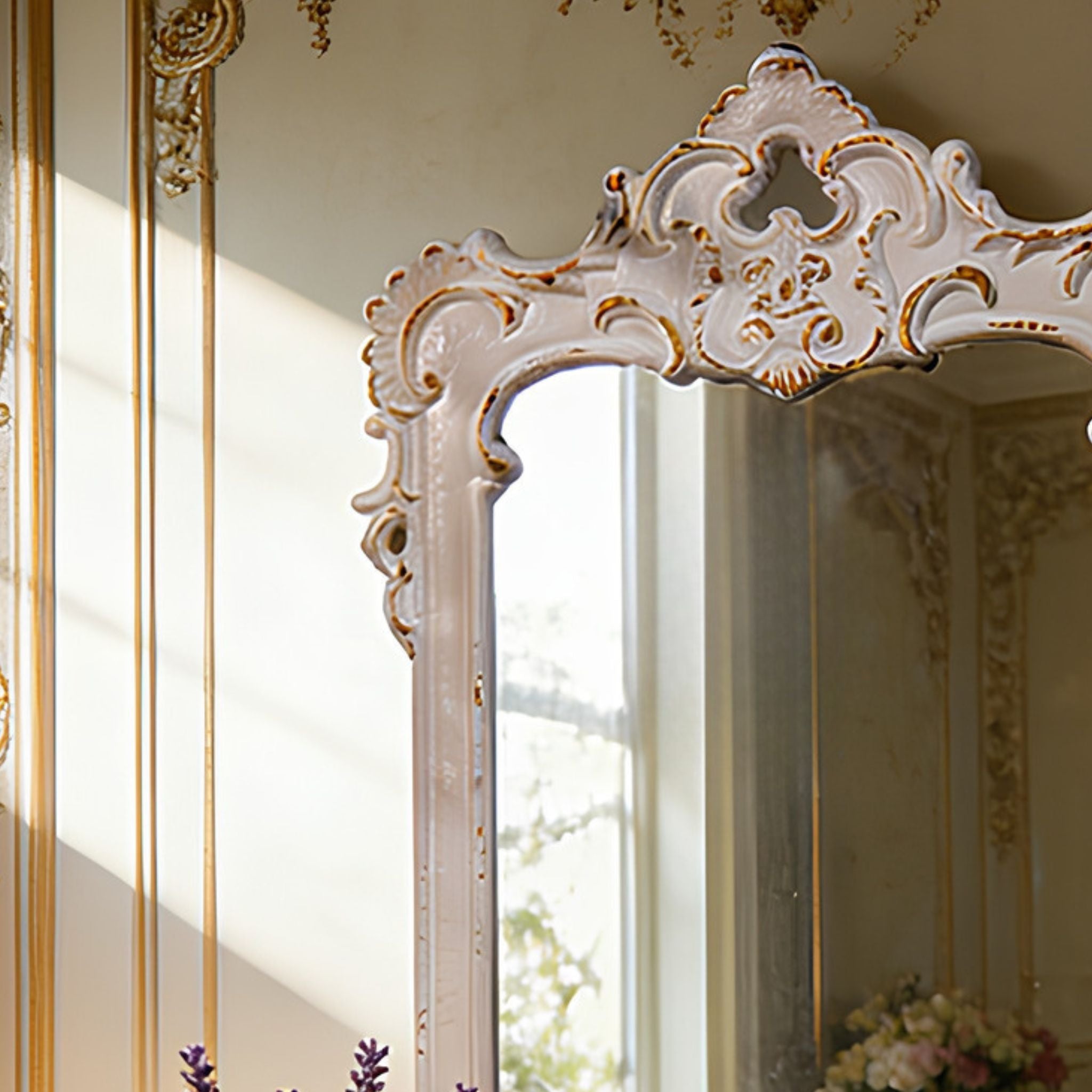 Close-up of Chambord's sculpted Baroque cartouche crown showing the trefoil cut-out, acanthus scrolls and worn antique white over warm gold accents.