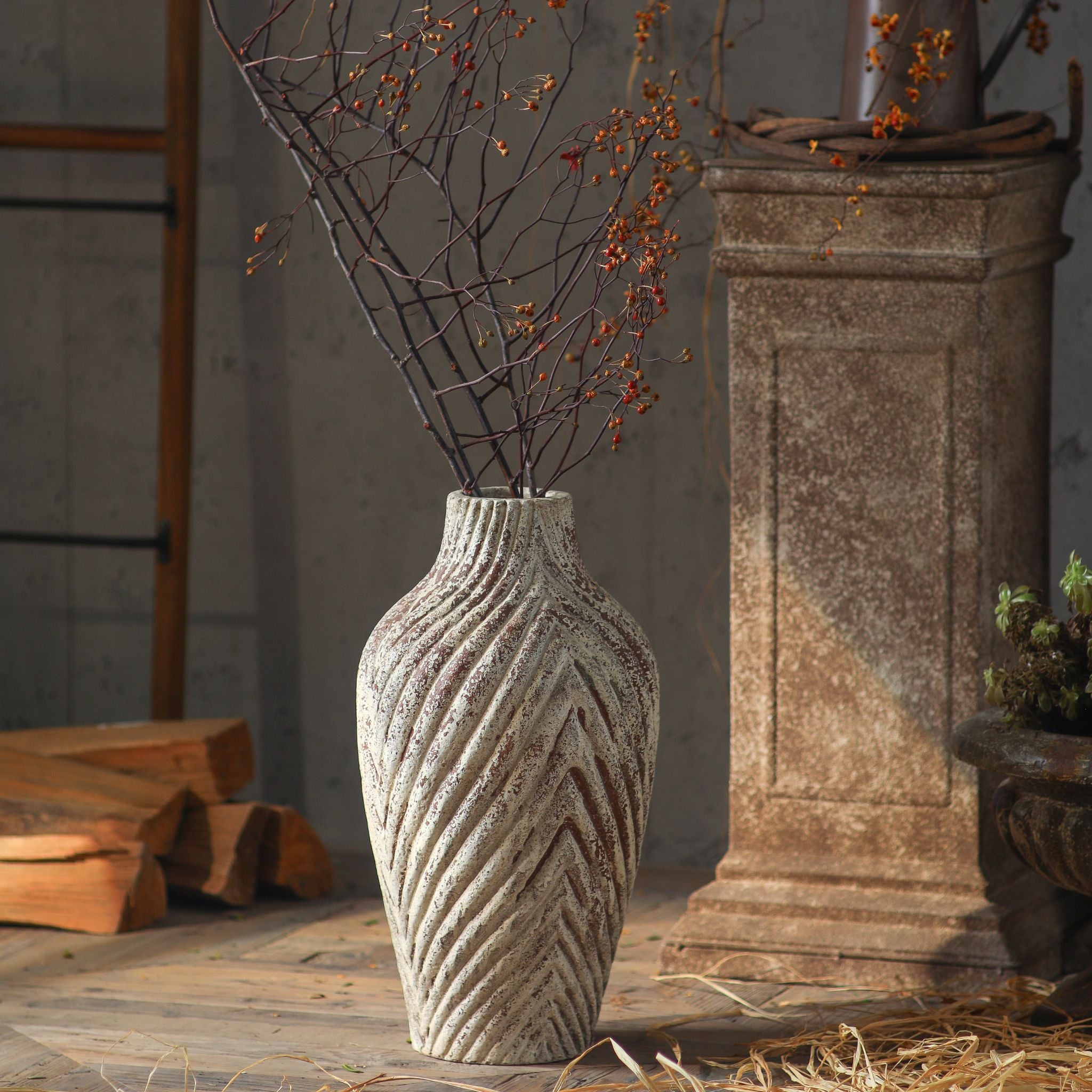 Clement chevron vase styled with branches, full height shown