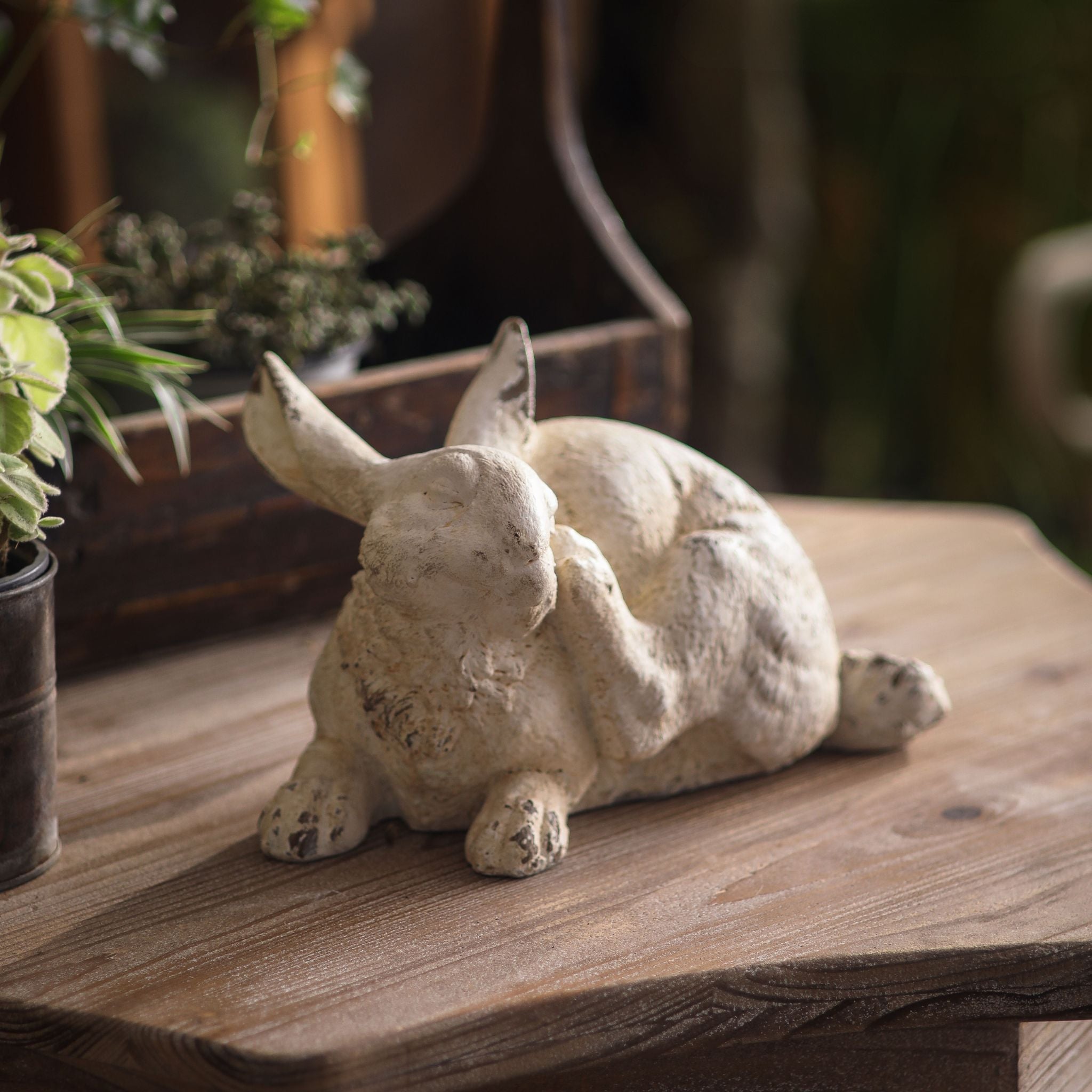 Coco scratching rabbit statue, 30cm, three-quarter view showing raised paw and aged whitewash finish