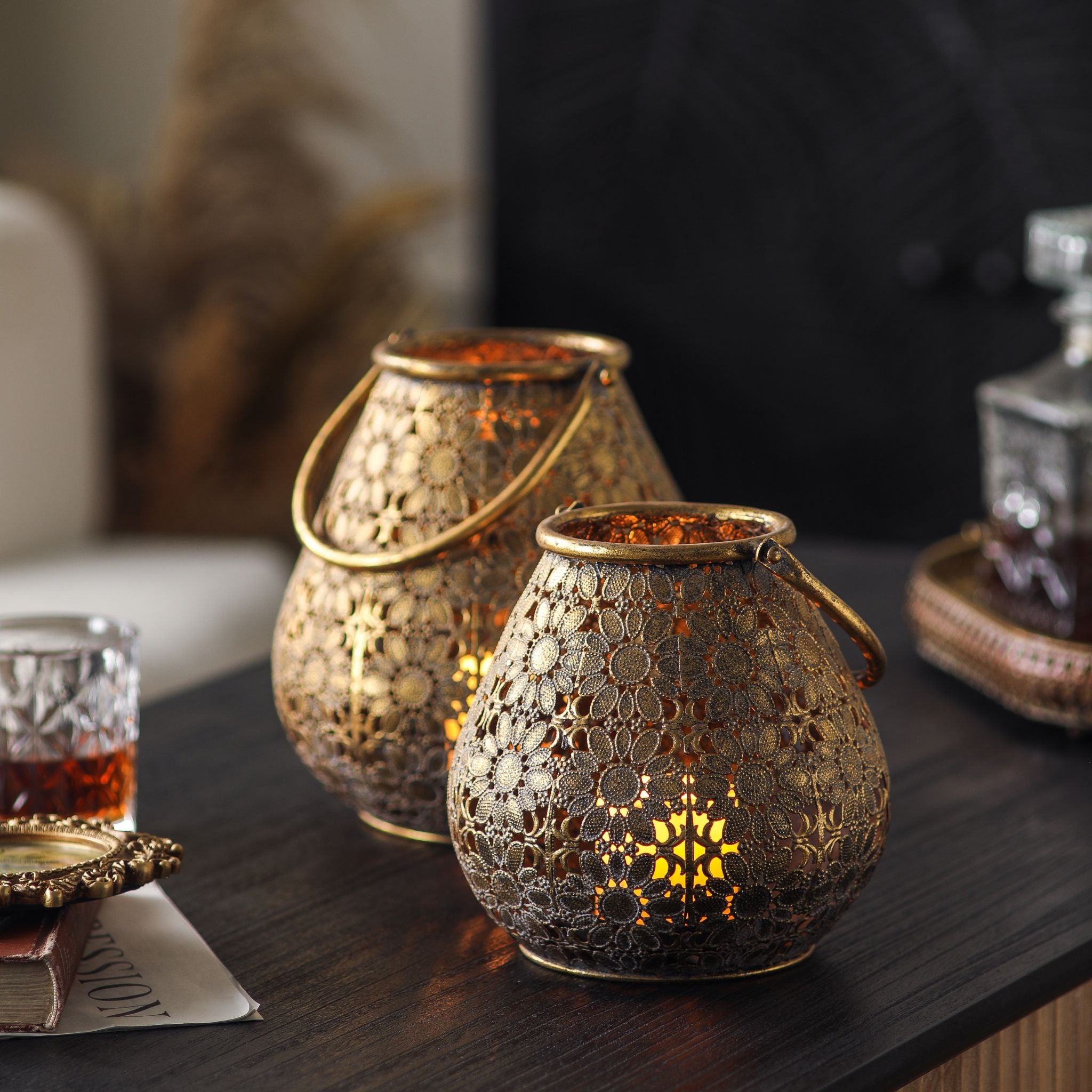 Two floral filigree lanterns showing the antique gold finish