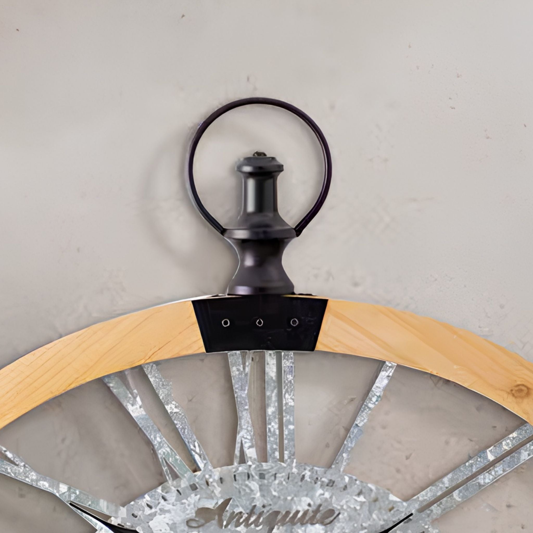 Detail of the Maude clock black metal crown and hanging loop at the top