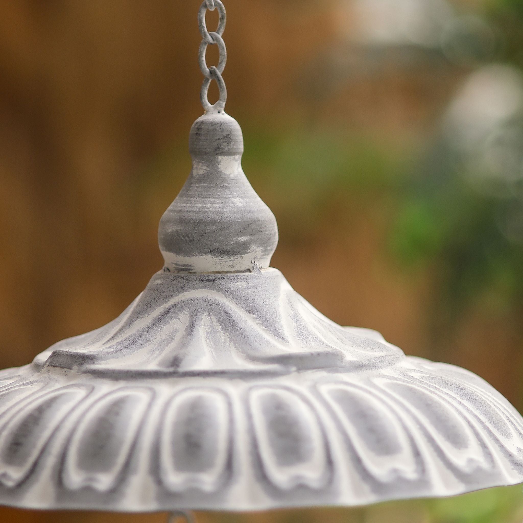 Close-up of the fluted domed roof and finial on the Dannielle hanging bird feeder.