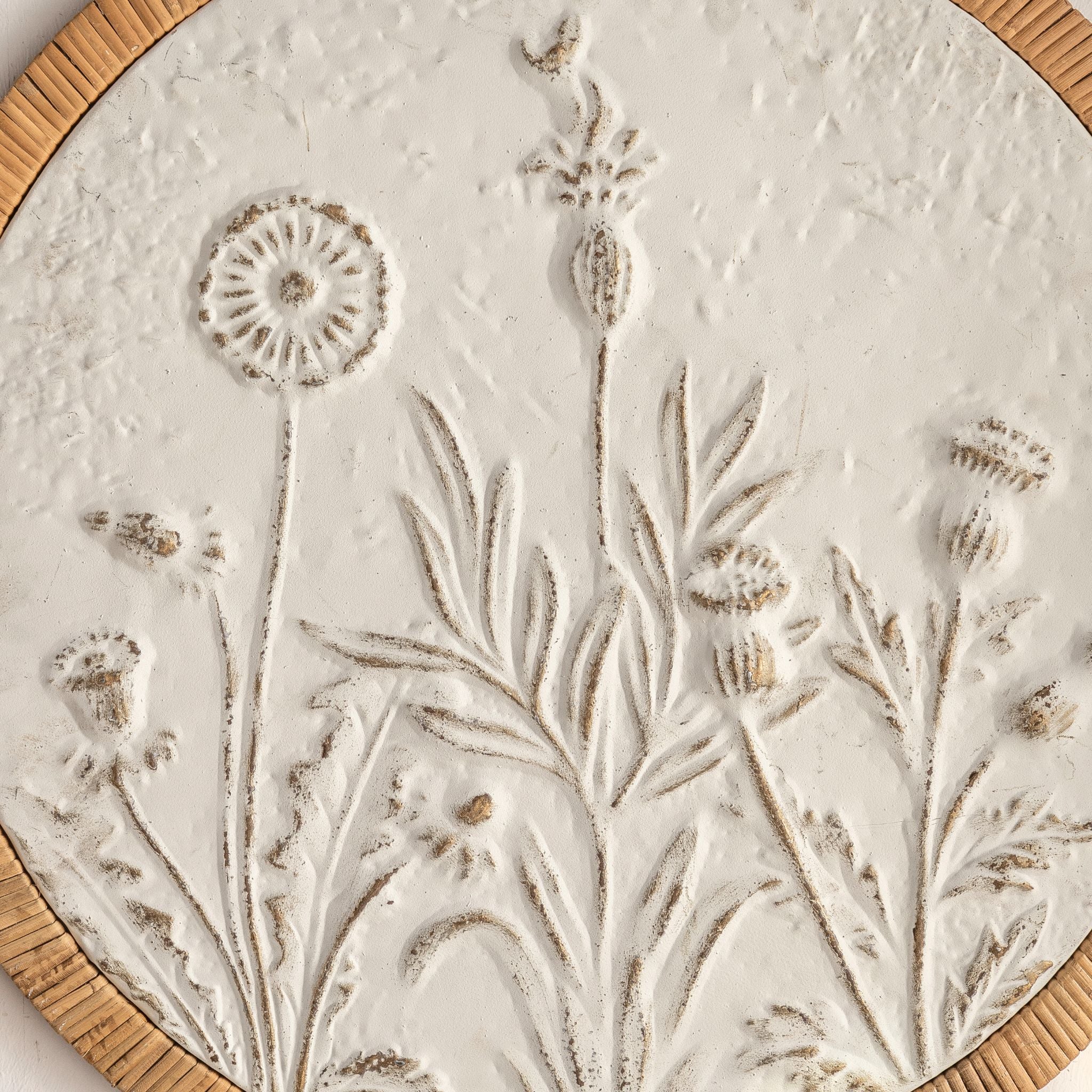 Close-up of the embossed meadow relief on the Dumas panel, distressed white with aged tones.