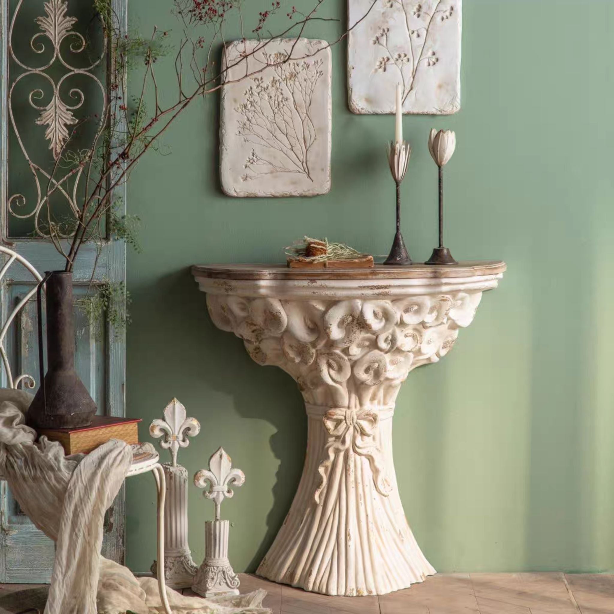Celestine wall console styled against a sage green wall with candlesticks and branches