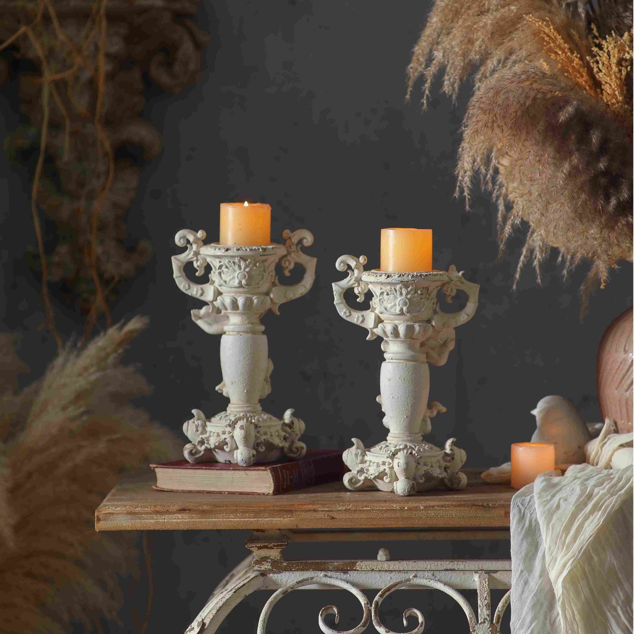 Claude and Jean Paul cherub candle holders rear view styled together with pillar candles, each sold separately
