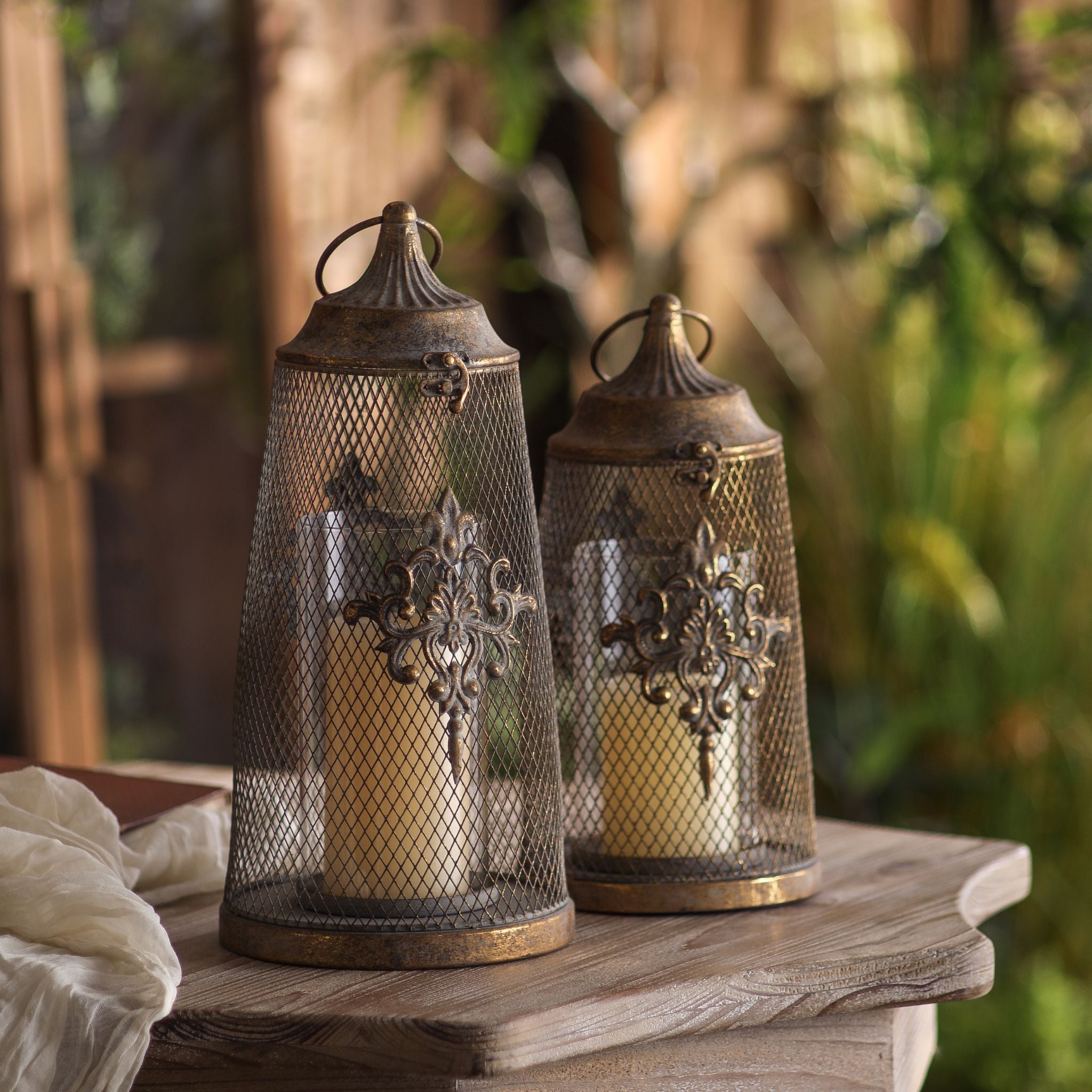 Stephanie and the shorter Sophie candle lanterns styled together outdoors at golden hour, each sold separately