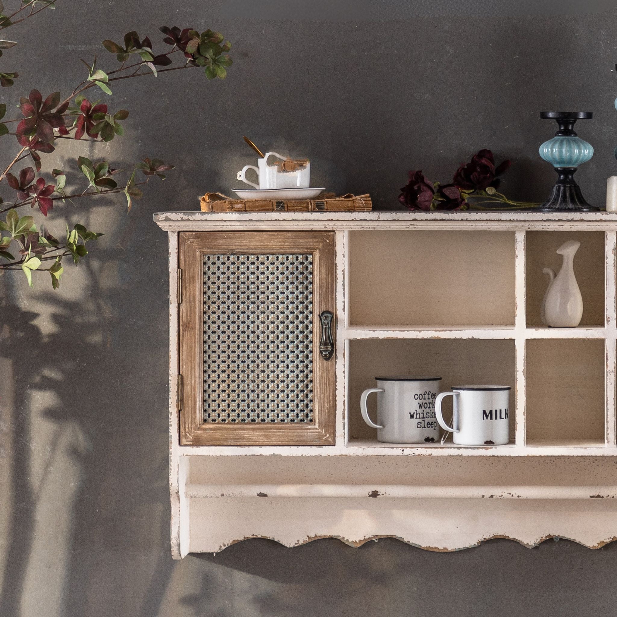 Guy wall shelf, angled view of the timber mesh-front cupboard door and the open cubbies.