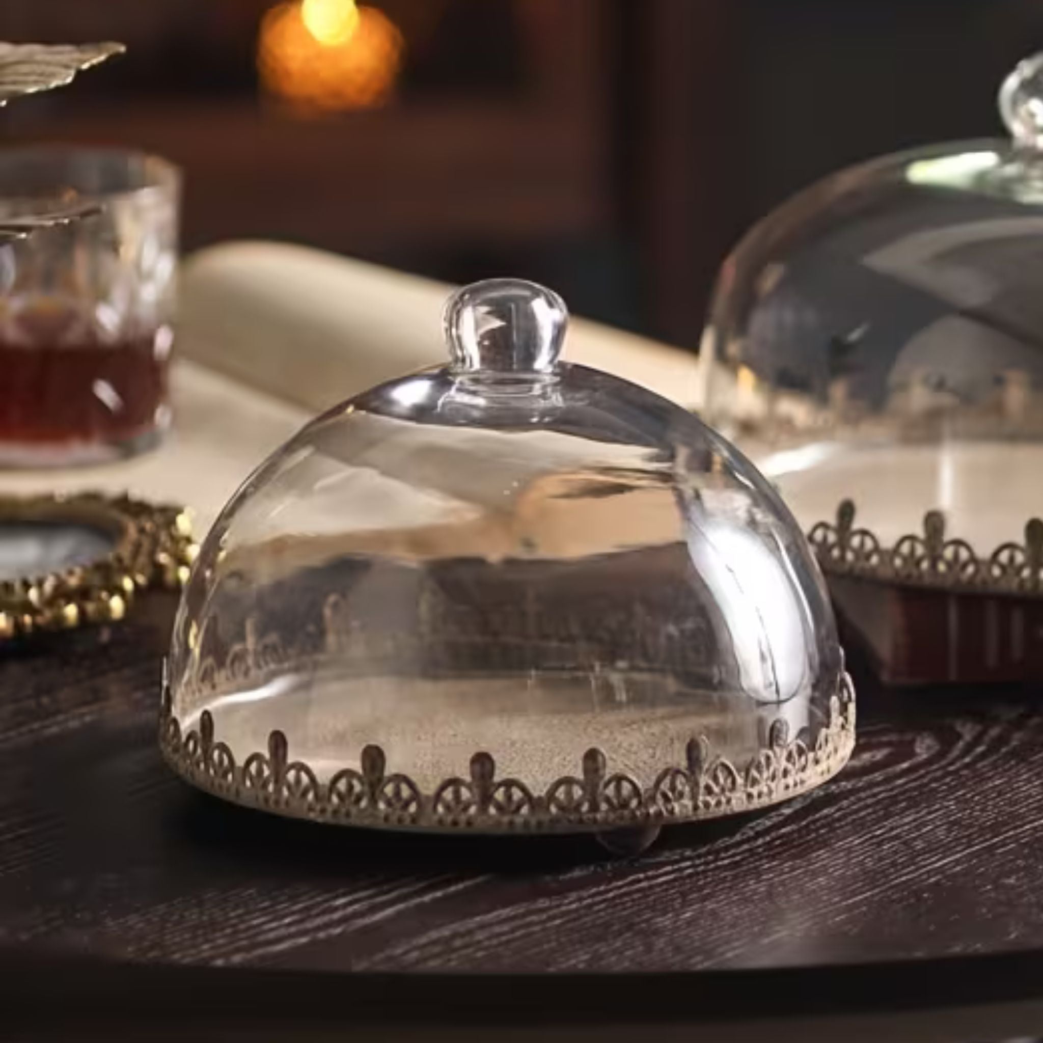 Honorine French Provincial glass cake dome on a footed metal tray with a pierced crown edge in distressed antique gold